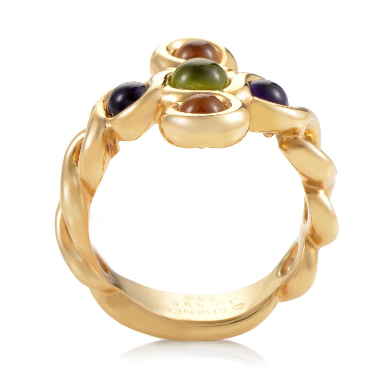 An array of hues are granted space and light in which to play across the crown of this gorgeous ring from Chanel. Purple, green and golden stones nestle comfortably in the pillow of 18K Yellow Gold that twists and falls into a bold band. Texture and