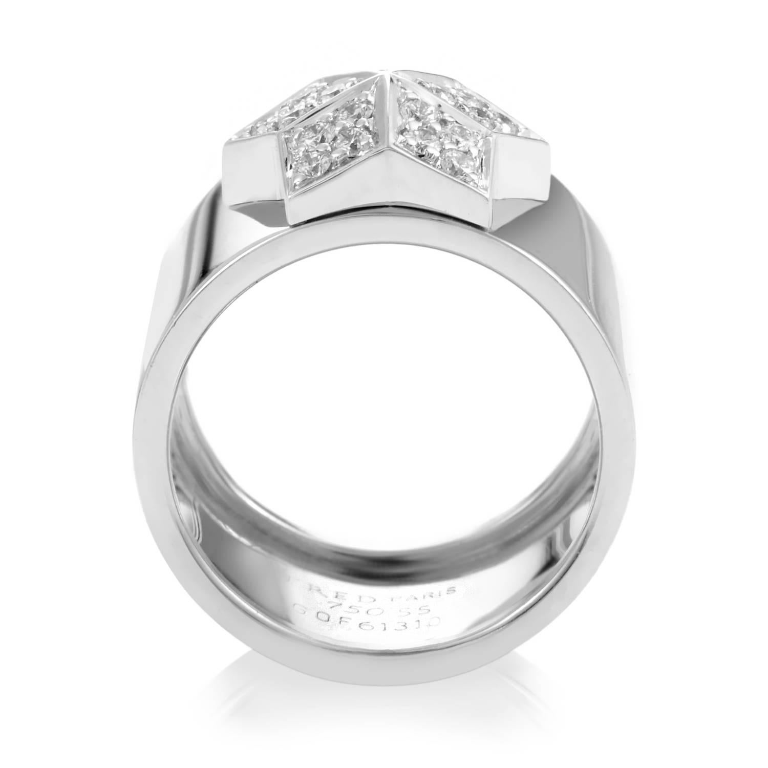 Fred of Paris has created an unabashed design bursting with timeless glare. Unlike shooting stars, this ring can be viewed again and again. The band is a wide tide of 18K white gold rolling up to showcase a platformed star motif. Each arm of the