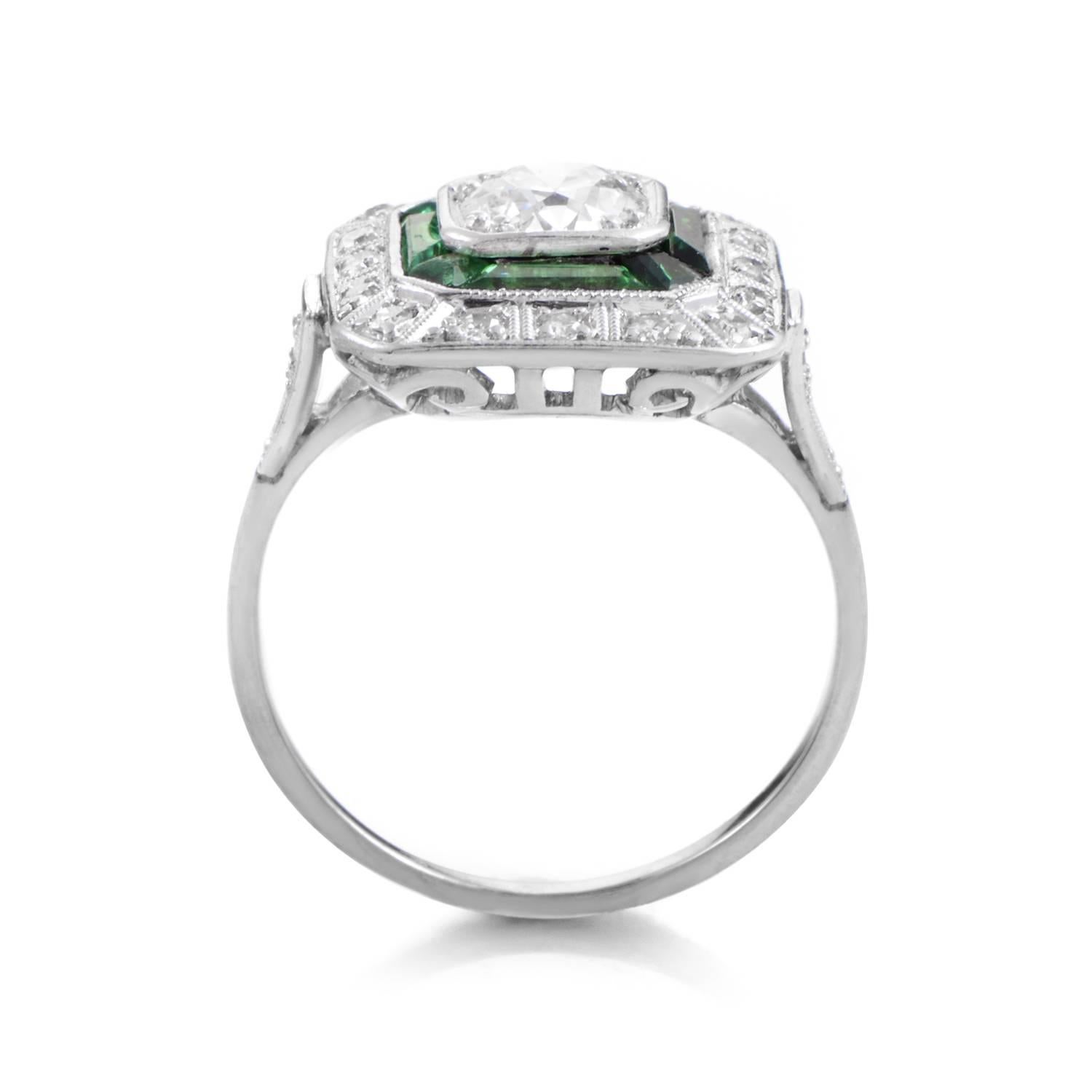 This finely crafted Art Deco style ring boasts a beauty that is hard to come across nowadays. The ring is made of 18K white gold and features a square-shaped bezel set with .20ct of diamonds. The bezel is also set with rich, green emeralds- all of