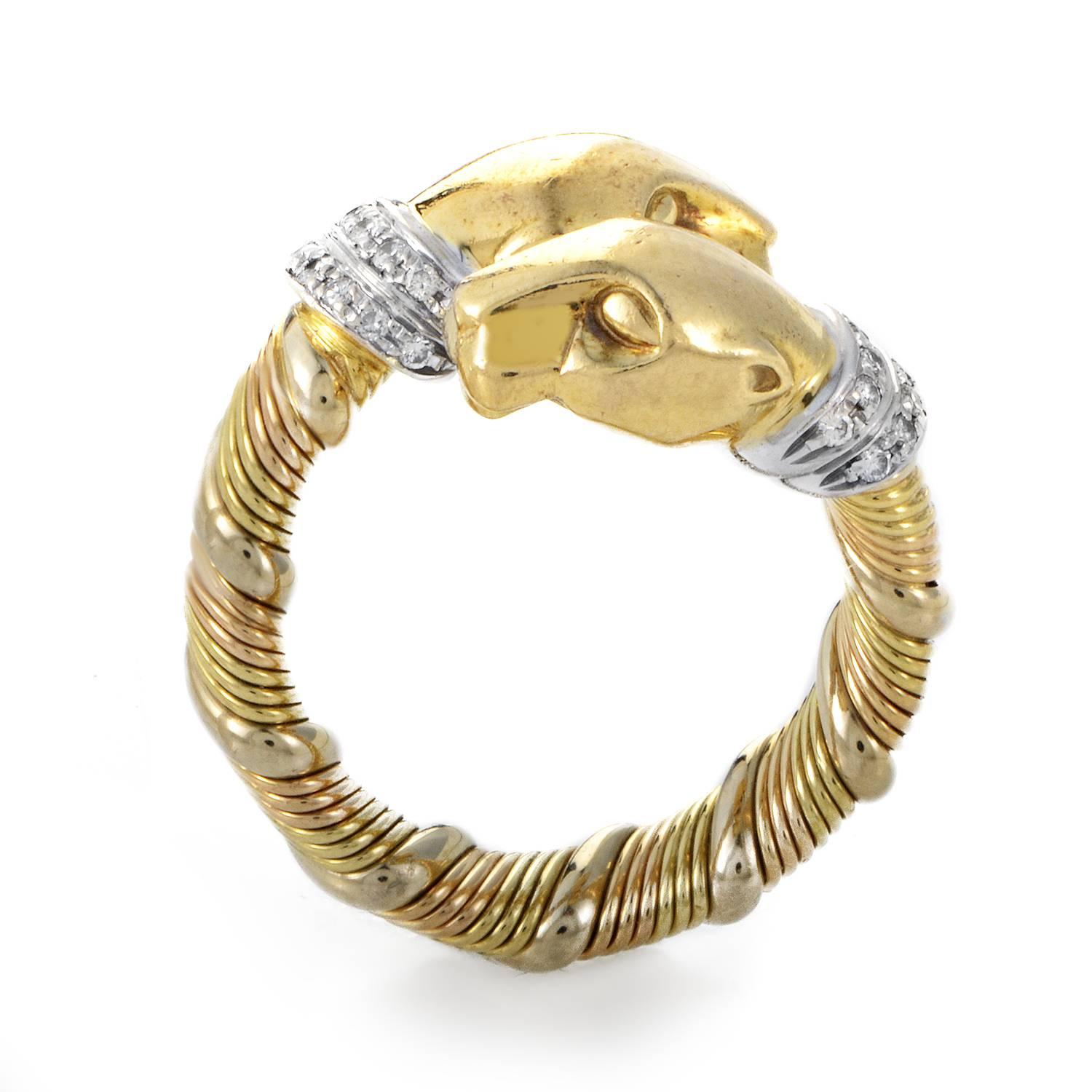 An exotic feline motif takes center stage atop this intriguing and beautifully crafted ring from Cartier. The band rises in a textured coil, its twining reach combining 18K Yellow and Rose Gold. At its zenith two panther heads nuzzle, their snouts
