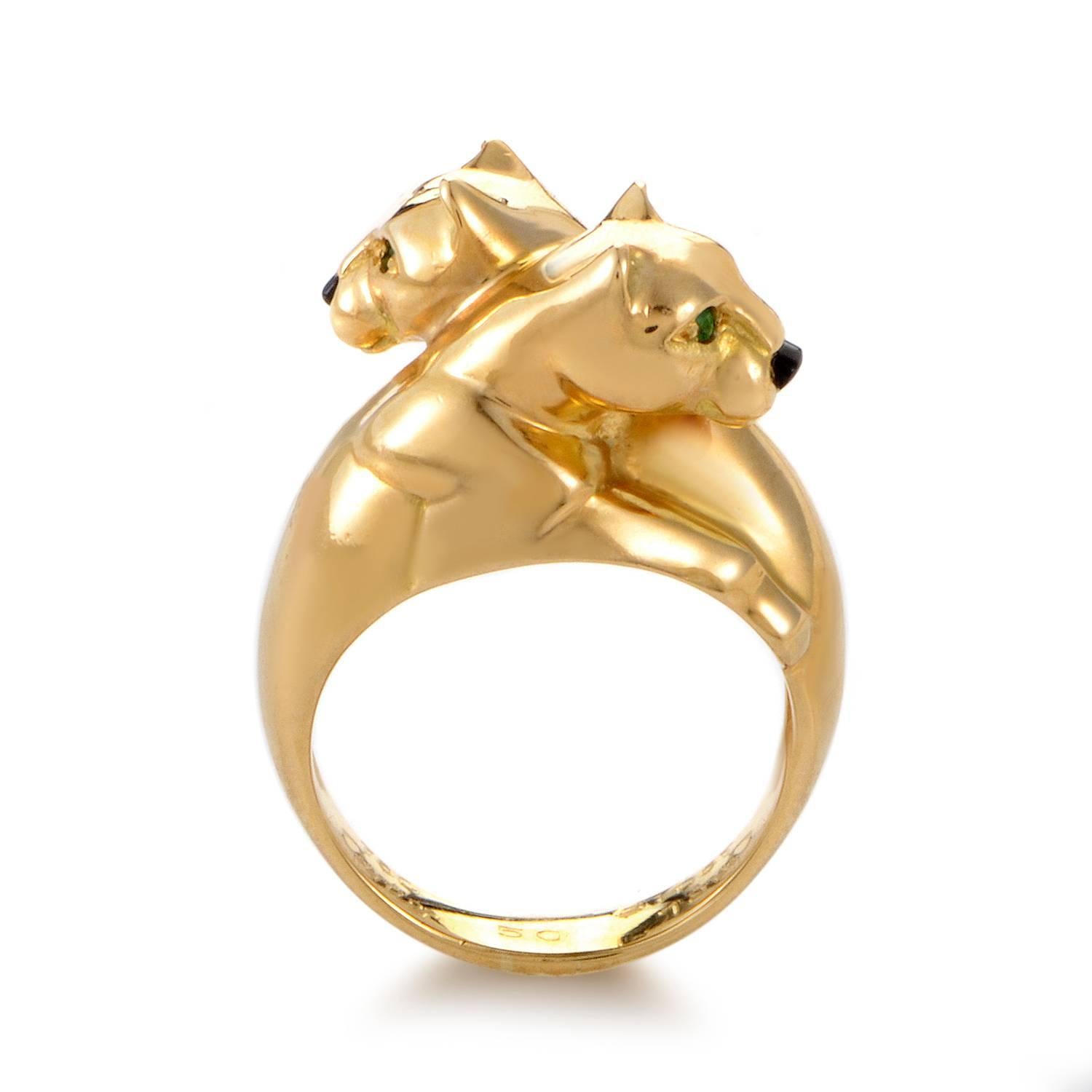 An exotic feline motif takes center stage atop this intriguing ring from Cartier. The band of 18K yellow gold rises into twin panther heads.Their snouts are shaped from onyx, their eyes made from shimmering emeralds. A unique extravagance in