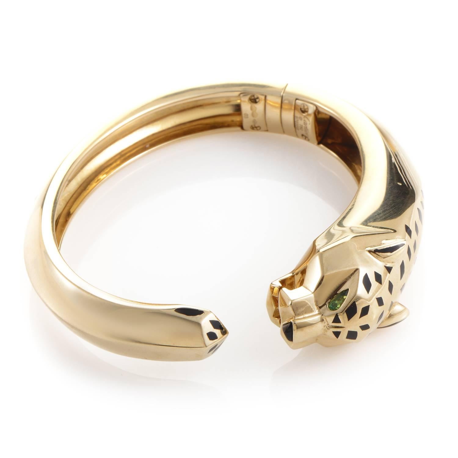 This bangle bracelet from Cartier's Panthere Collection is a gorgeous iconic piece. The bracelet is made of 18K yellow gold and is shaped in the likeness of a panther. The panther's head is accented with black lacquer spots and a black onyx nose.