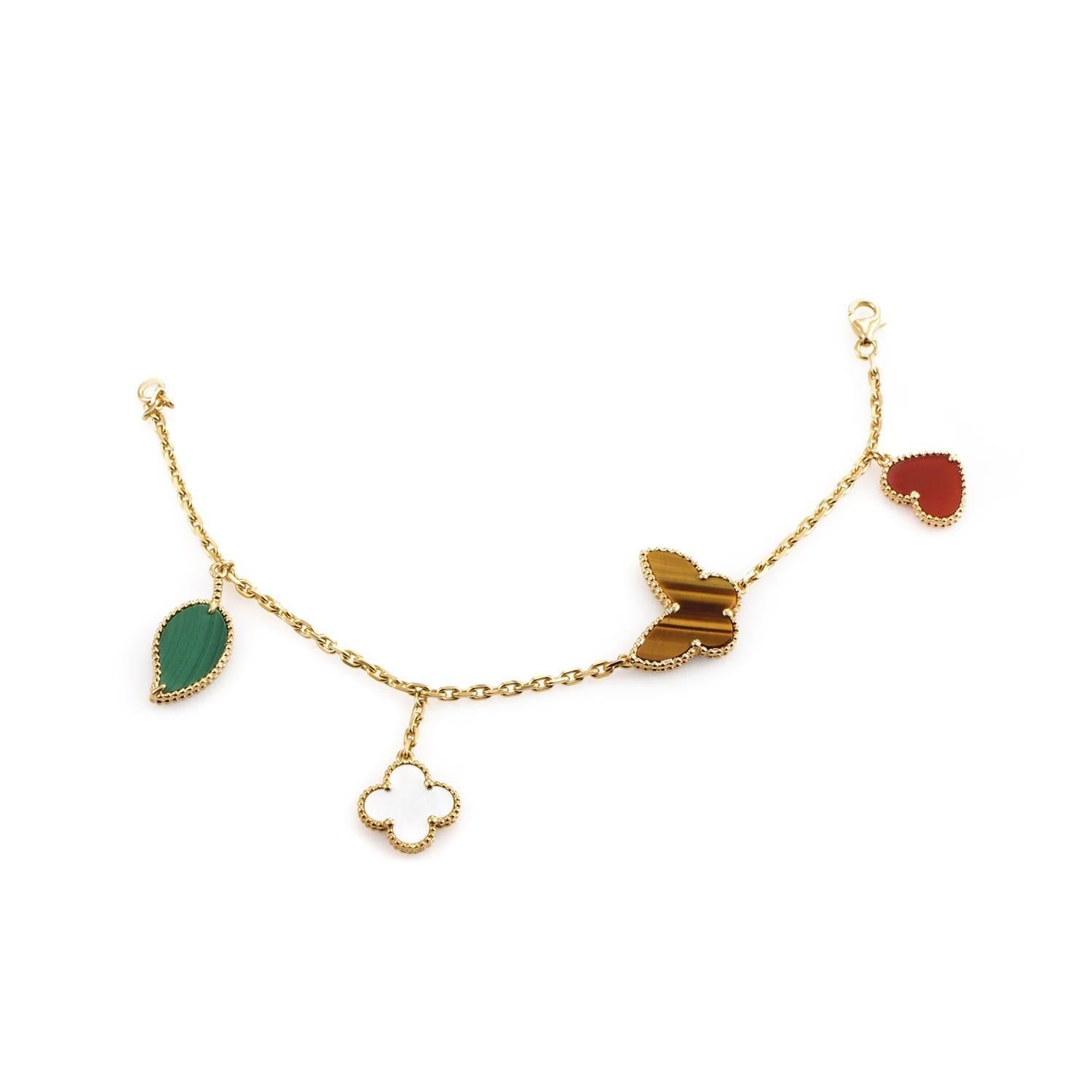 This dazzling charm bracelet from Van Cleef & Arpels Lucky Alhambra collection is absolutely adorable. The bracelet is made of 18K yellow gold and features four charms: a machinate leaf, mother of pearl Alhambra, tiger's eye butterfly, and a