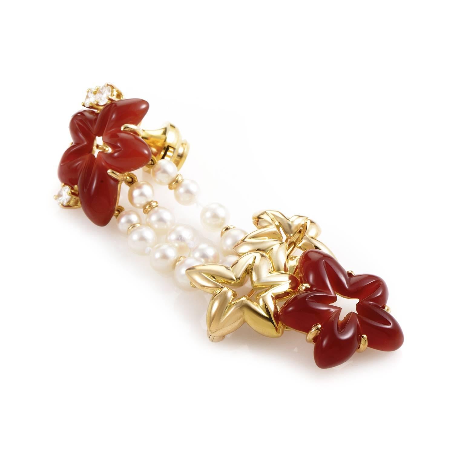 Vivid and exuberant in its tasteful selection of eye-catching colors, this majestic pin from Chaumet boasts lovely star-shaped decorations in 18K yellow gold and gorgeous brown jade, embellished also with ever-graceful pearls and glittering diamonds