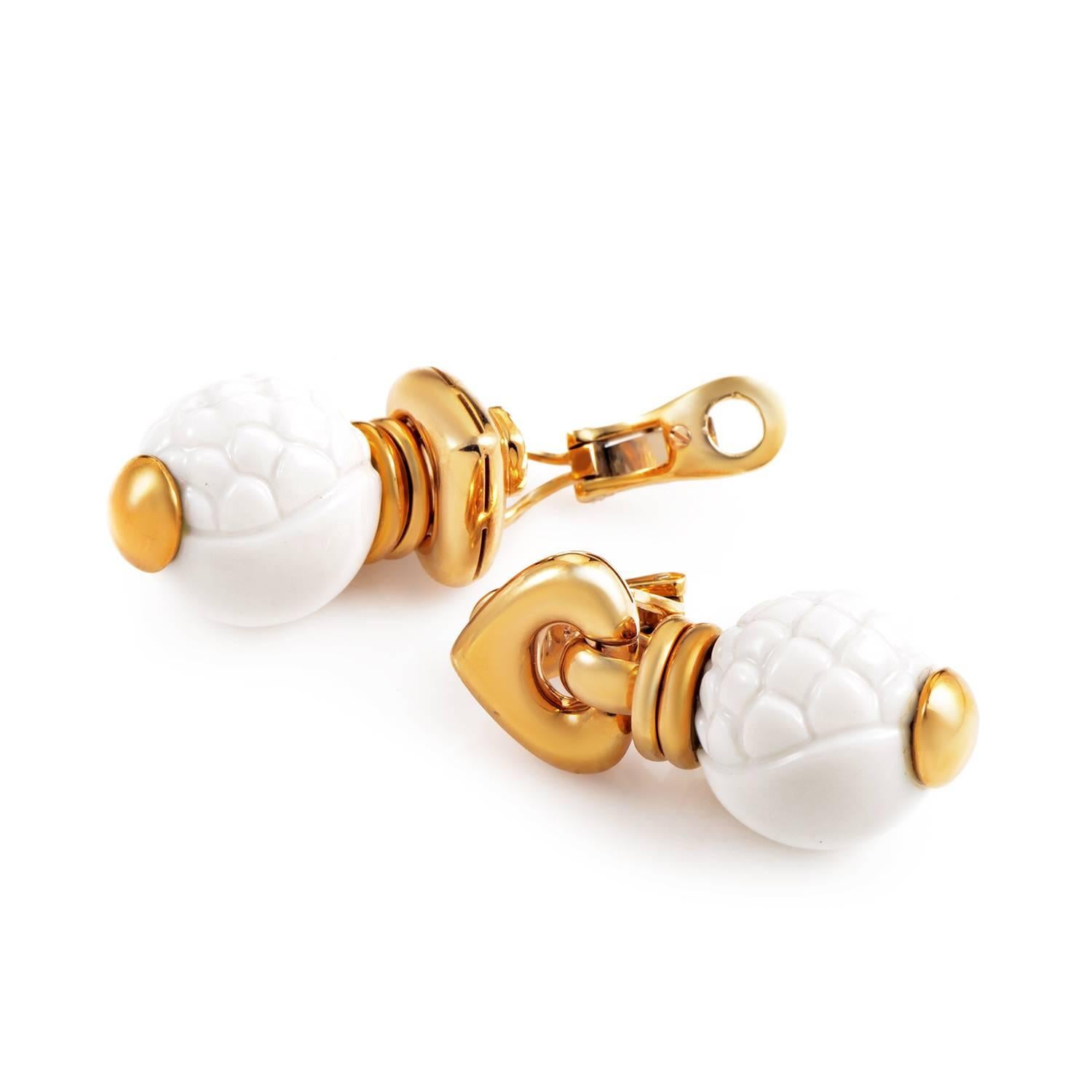 Boasting a rare and exotic look, this pair of earrings from Bulgari's Chandra collection are without comparison. The earrings are made of 18K yellow gold with delicate dangling white ceramic spheres. Each ceramic accent is painstakingly carved for