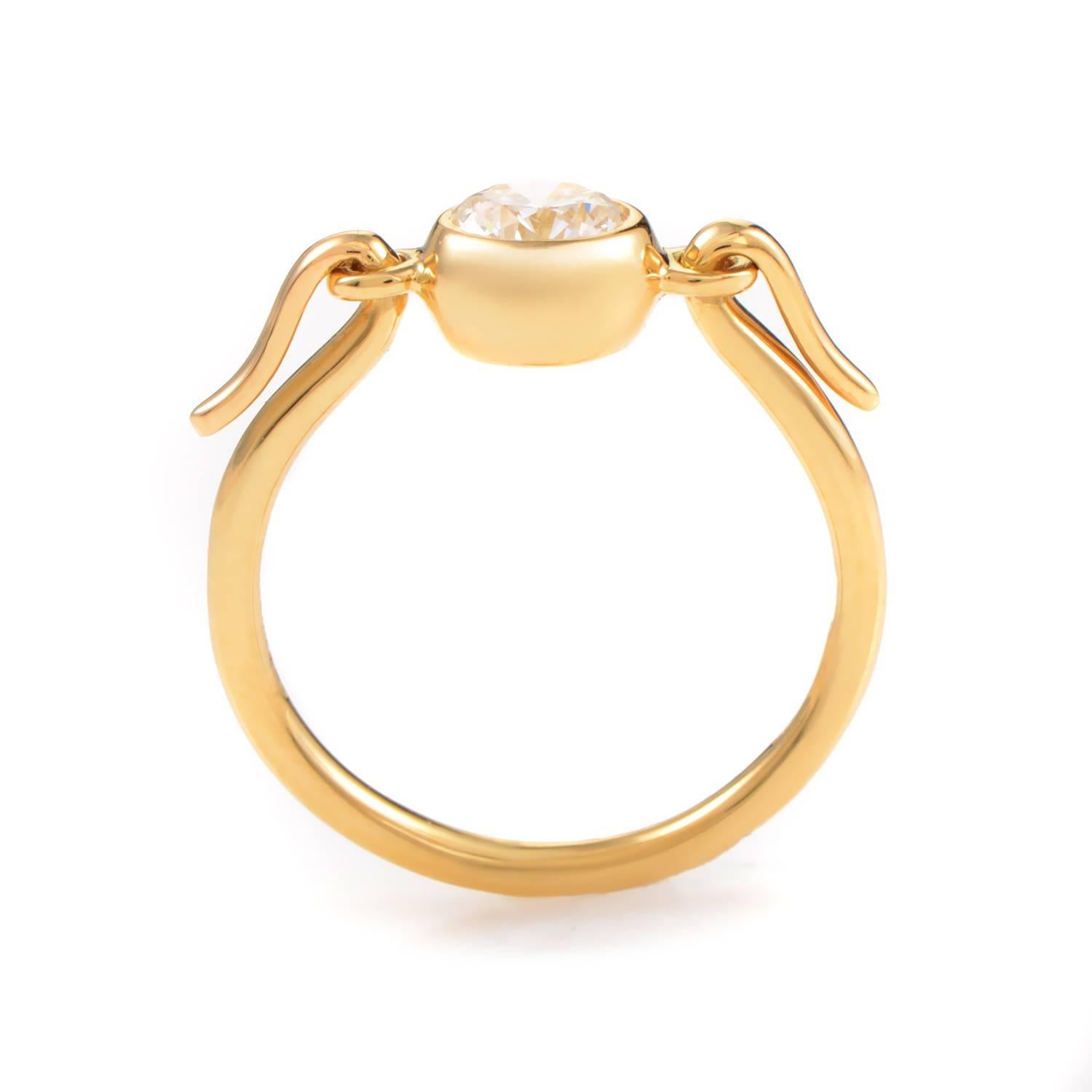 A seemingly classic design with an intriguing and graceful twist at the very top of this slim 18K yellow gold body, this enchanting ring from Tiffany & Co. is an epitome of gorgeous elegance and subtle luxury, boasting a glistening 0.70ct diamond
