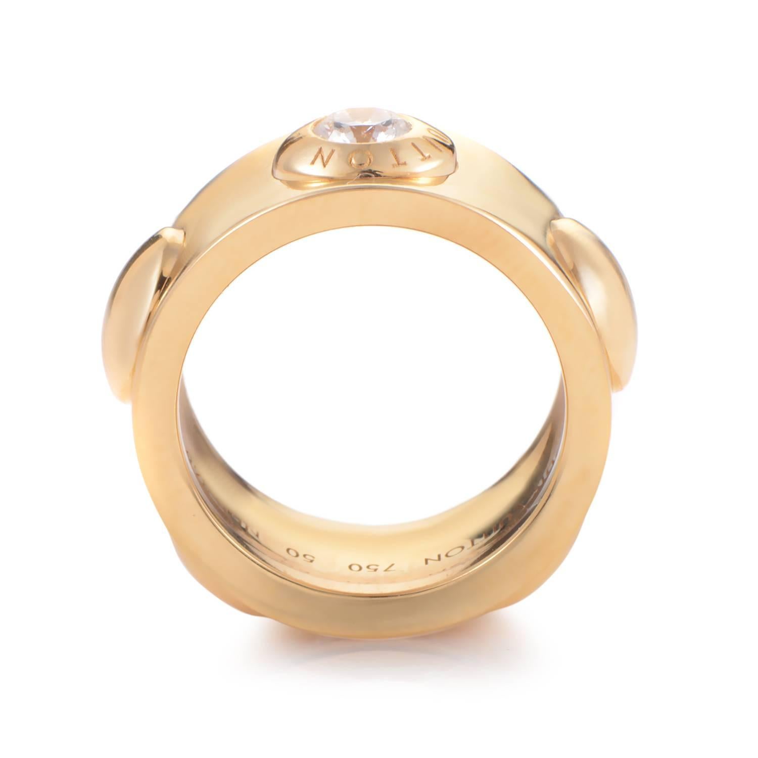 Louis Vuitton is a world wide icon of style, and the reason for this is evident in this bold 18K yellow gold ring. Domed gold punctuates the even shank with a stunning ~.40ct diamond that is encircled by the inscribed Louis Vuitton name providing an