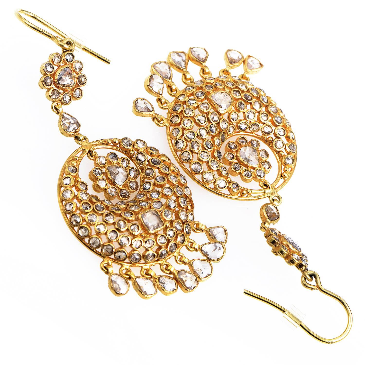 A spellbinding sight and an artistically brilliant design, these fascinating earrings embellish the enchanting radiance of exceptionally shaped 24K yellow gold with scintillating setting of rose-cut diamonds weighing in total approximately 5.00