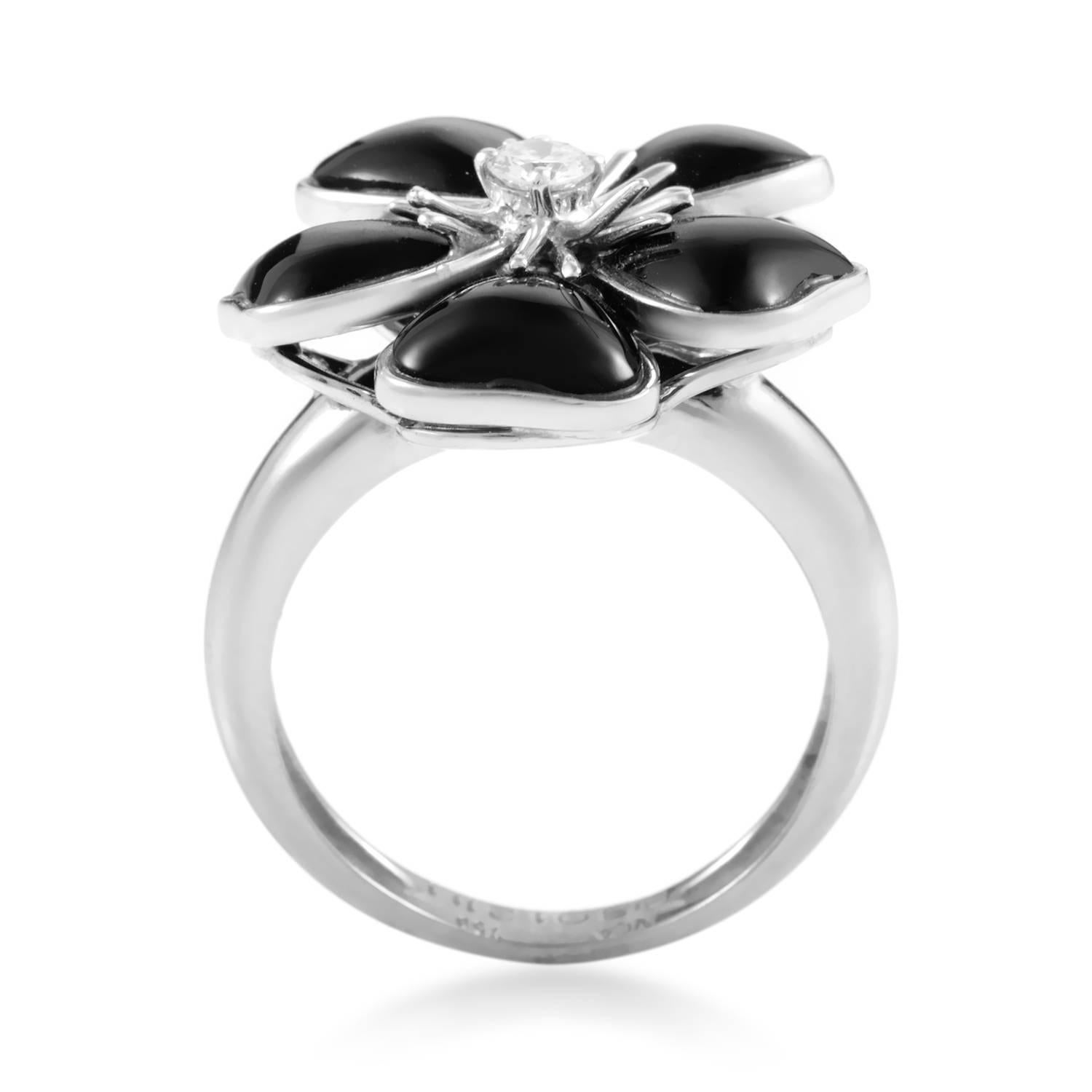 A splendid interpretation of the charming flower motif in the most stunning of contrasts, this outstanding ring from Van Cleef & Arpels combines shimmering 18K white gold and luscious diamonds totaling 0.15 carats with captivating onyx stones posing