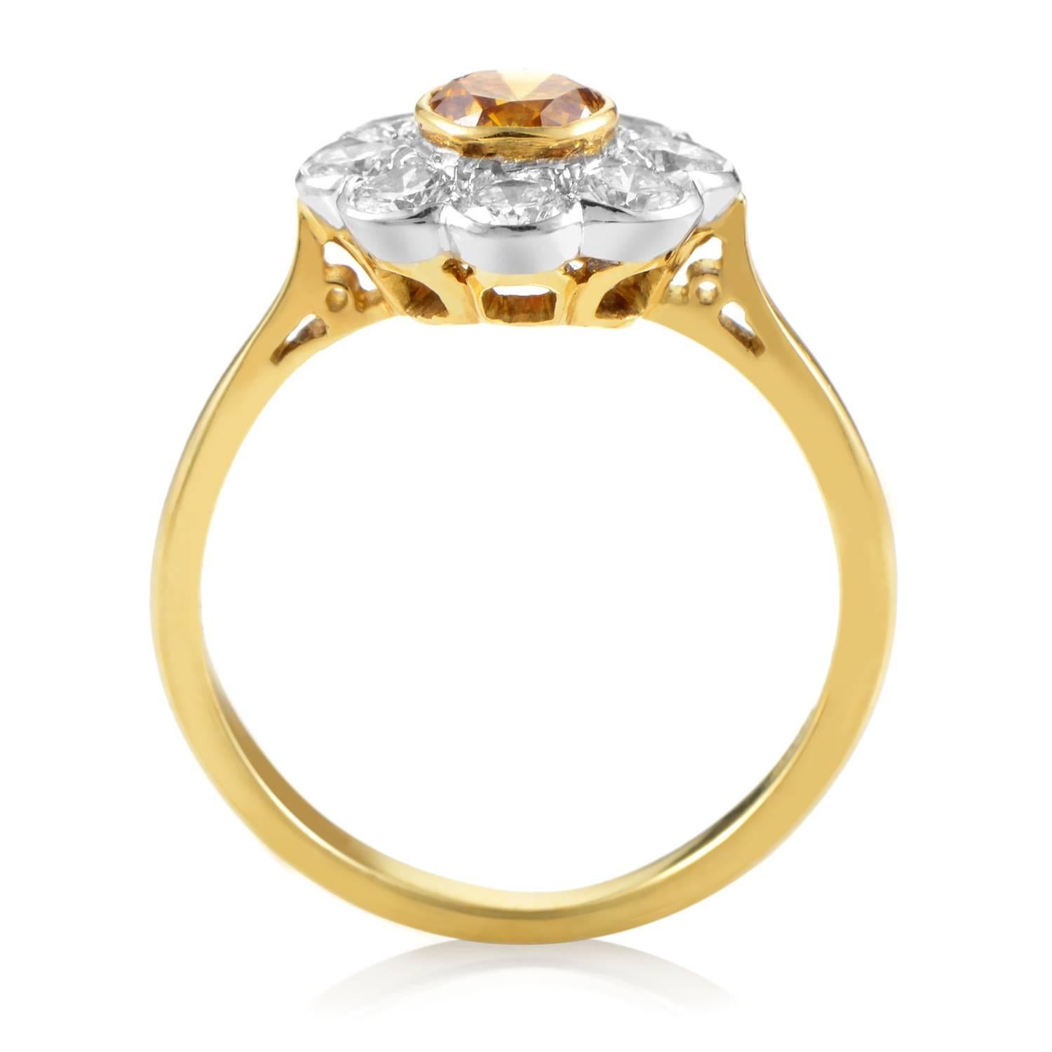 Creating a wonderful backdrop for the fascinating central orange diamond weighing approximately 0.35 ct, this delightful ring from Garrard boasts a neat body made of 18K yellow and white gold and embellished with 0.65 ct of sparkling white