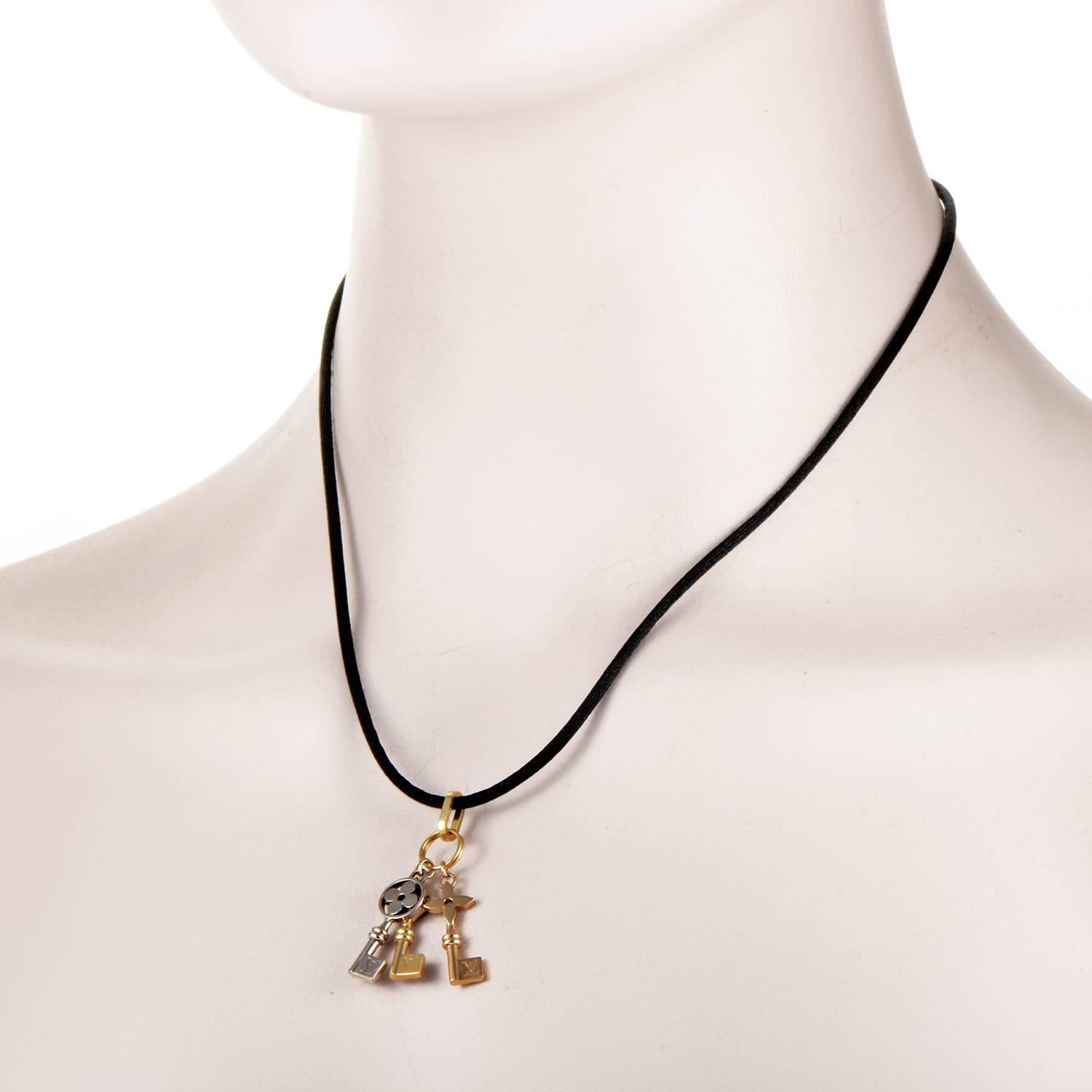 Featuring an elegantly simple black cord and brilliantly contrasting 18K yellow and white gold, this is a visually strong and marvelously appealing necklace from Louis Vuitton, boasting lovely key-shaped charms with intriguing flower symbols as