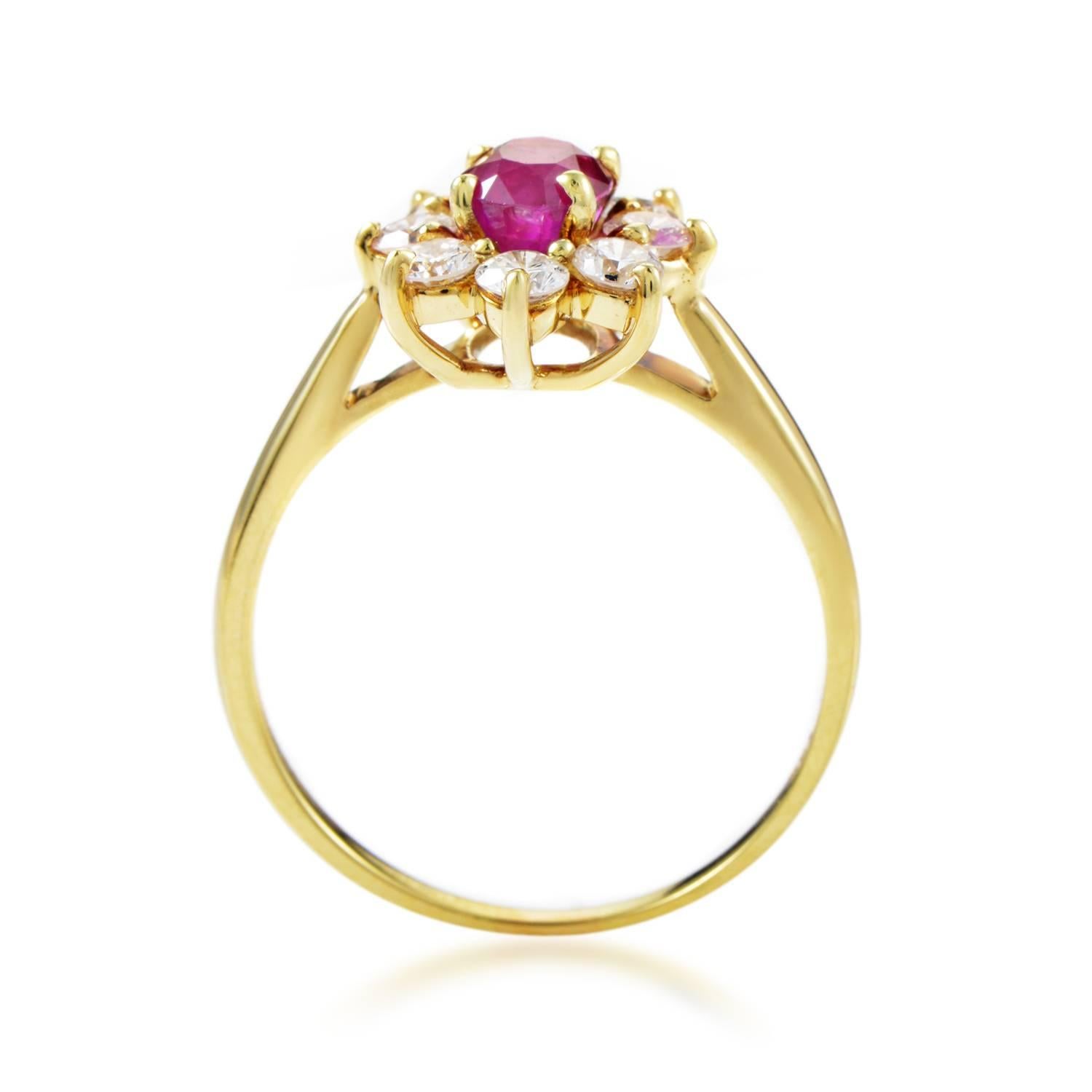 A glamorous depiction of a flower where lustrous diamonds totaling 0.80ct surround a majestic central ruby weighing 1.00 carat as brilliant sparkling petals upon a gracefully slim 18K yellow gold body, this delightful ring is a fascinating item from