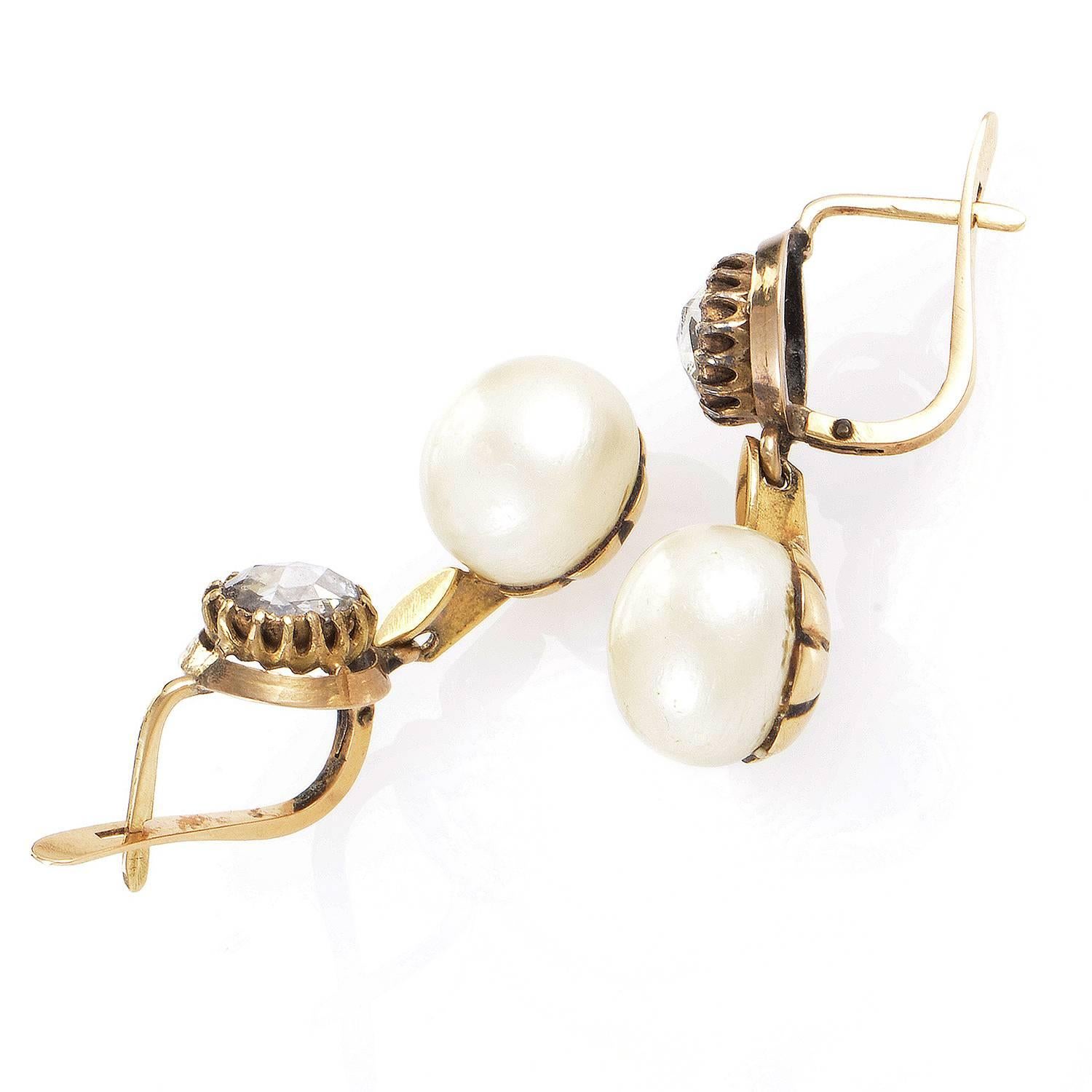 The classic luxurious blend of charming 18K yellow gold and lustrous diamonds weighing in total approximately 1.50 carats is perfectly complemented by the gorgeous pearls and their traditional allure in these nifty and tasteful earrings.