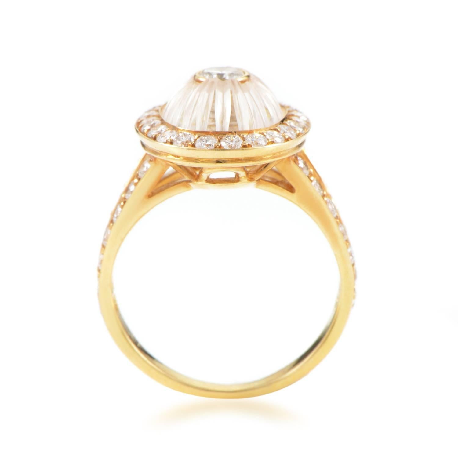 Like an iris of a marvelous eye, the glistening white crystal encircles the striking central stone of this spellbinding 18K yellow gold ring from Boucheron, while glittering diamonds set underneath bring the total weight to 0.90ct of lovely