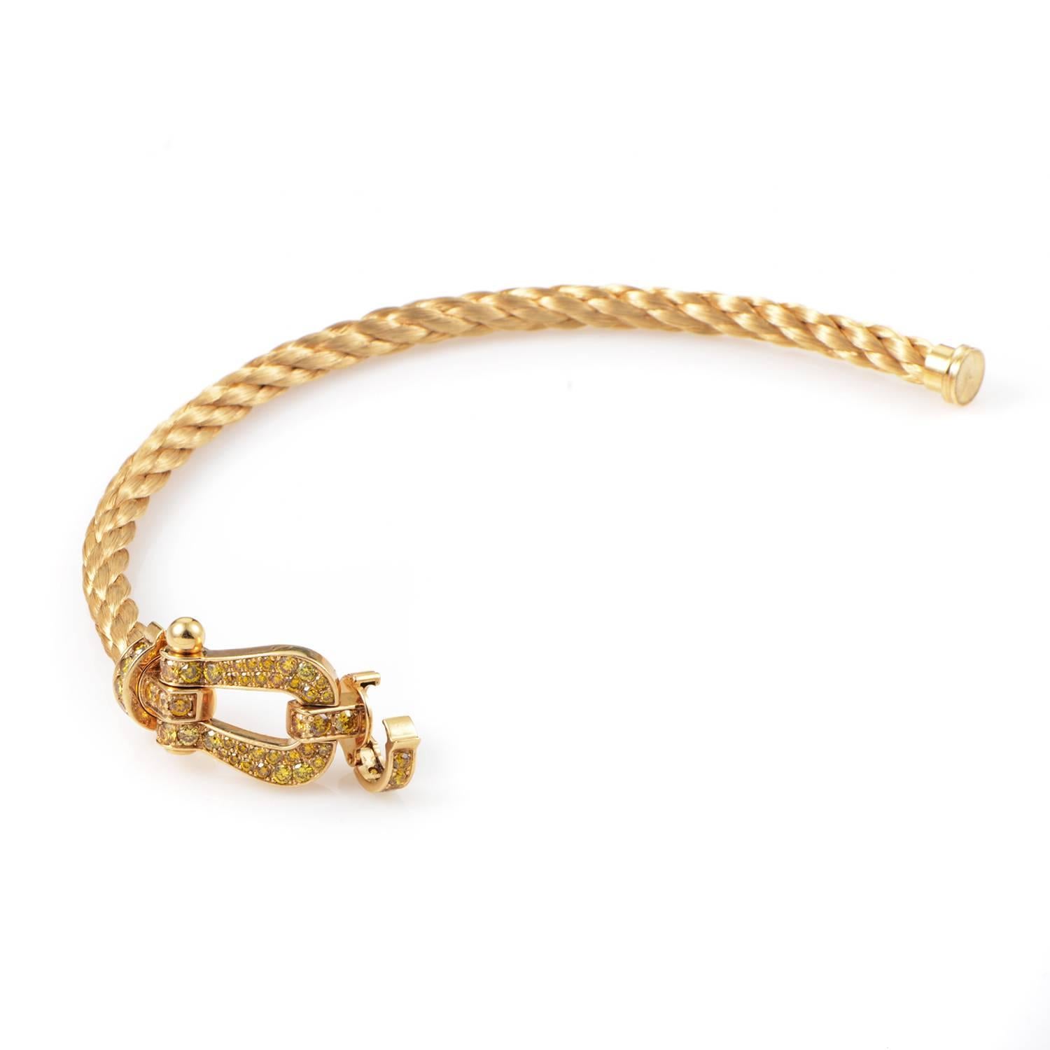 Braided to create a fabulous texture and scintillating play of light, this stunning bracelet from Fred of Paris boasts a charming horseshoe motif next to its clasp, with 1.60 carats of gorgeous vivid yellow diamonds gracing the warm surface of 18K