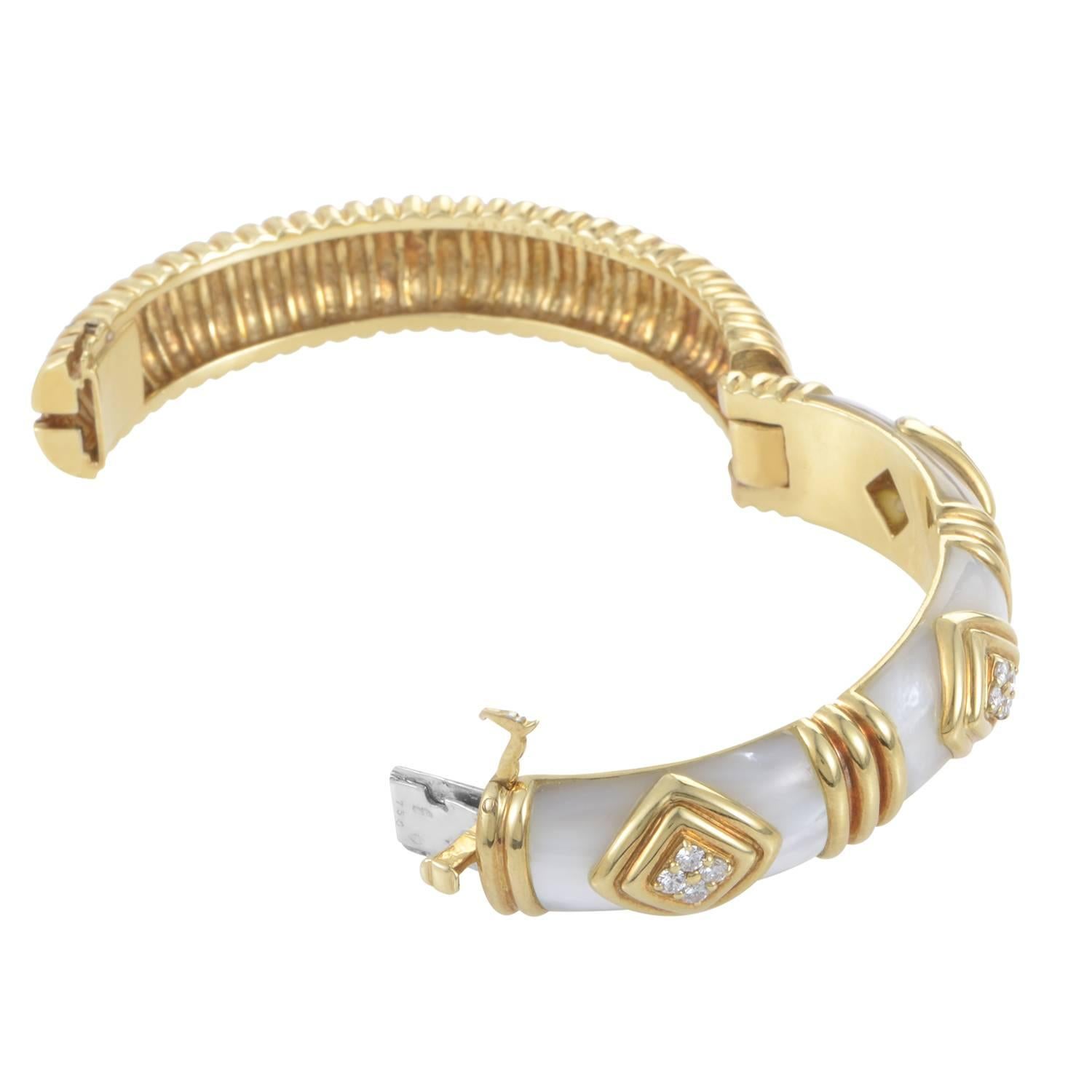 The fiercely feminine design of this bangle bracelet from Van Cleef & Arpels is without comparison. The bracelet is made of 18K yellow gold and is accented with lustrous mother of pearl. Lastly, .50ct of diamond adornments add a hint of sparkle to
