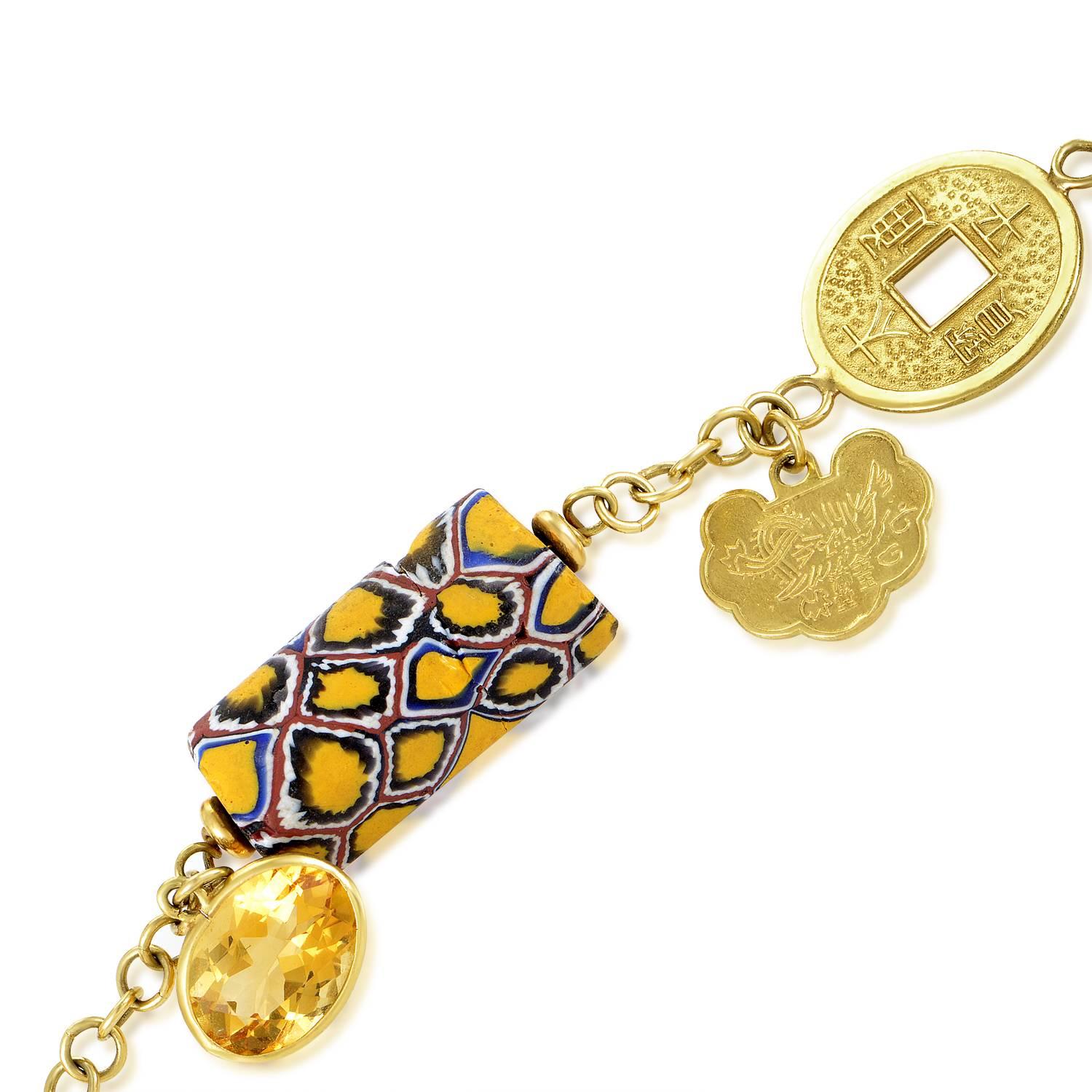 A breathtaking composition of diverse and pleasantly harmonious charms, this exceptional necklace from Dada is made of 18K yellow gold and boasts sparkling citrine stones, marvelous resin ornaments and adorable Chinese coins for a fantastic appeal.