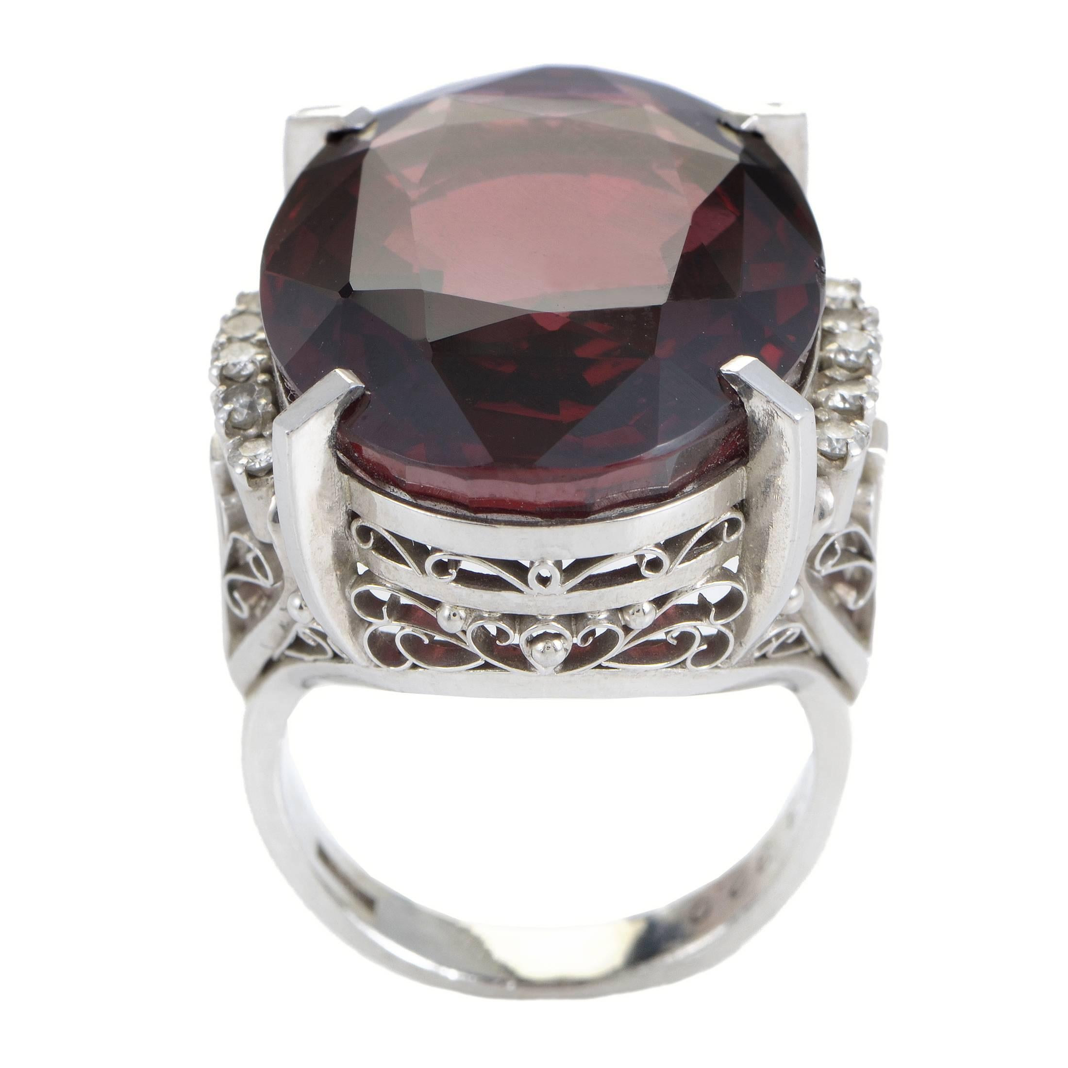 Creating a splendid aura of beauty through the stunning color and exceptional cut of the gorgeous tourmaline as well as the magnificent ornamentation surrounding it, this marvelous ring is made of platinum and embellished also with 0.15ct of