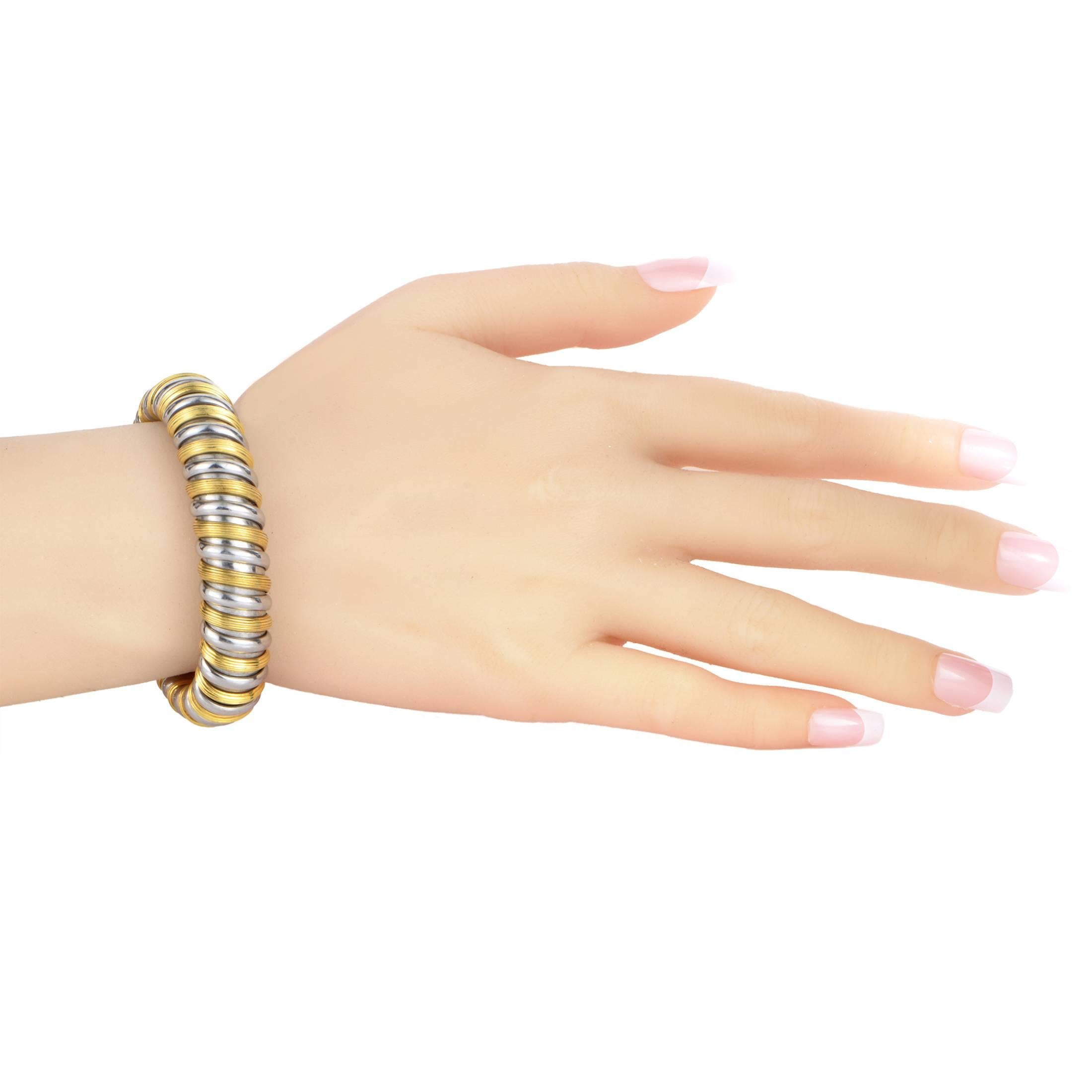 Two contrasting colors with fascinating gleam coil around this outstanding bracelet from Bulgari which is made of splendid stainless steel and luxurious 18K yellow gold for a mesmerizing visual effect.
Included Items: Manufacturer's Box