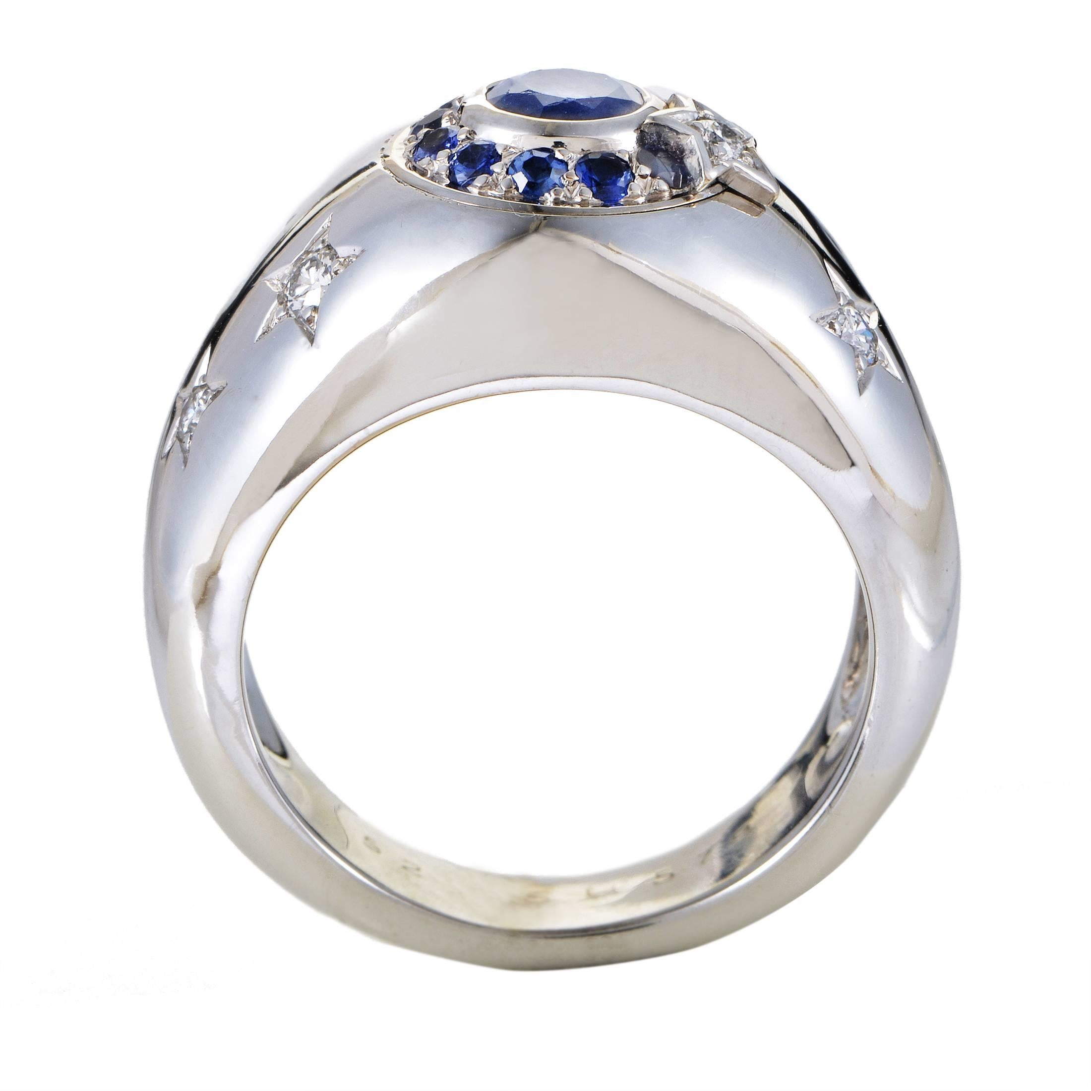 With the magnificently shaped central sapphire and numerous smaller ones around it lending their compelling color to the harmoniously bright design, this outstanding ring from Chanel is made of 18K white gold adorned with glittering diamonds and