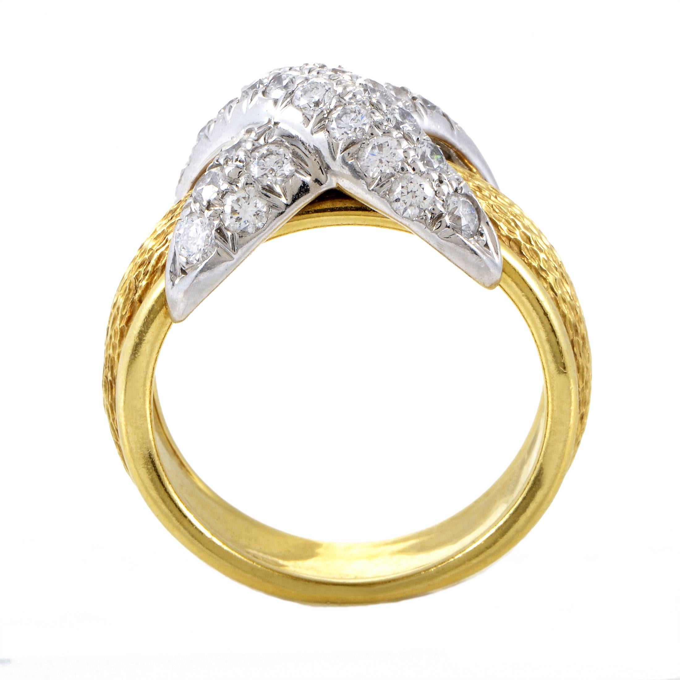 Embellished with resplendent diamonds weighing in total 1.00 carat and firmly embracing the intricately ornamented 18K yellow gold band, the fantastic platinum charm adds eye-catching brightness to this exceptional ring designed by Jean Schlumberger
