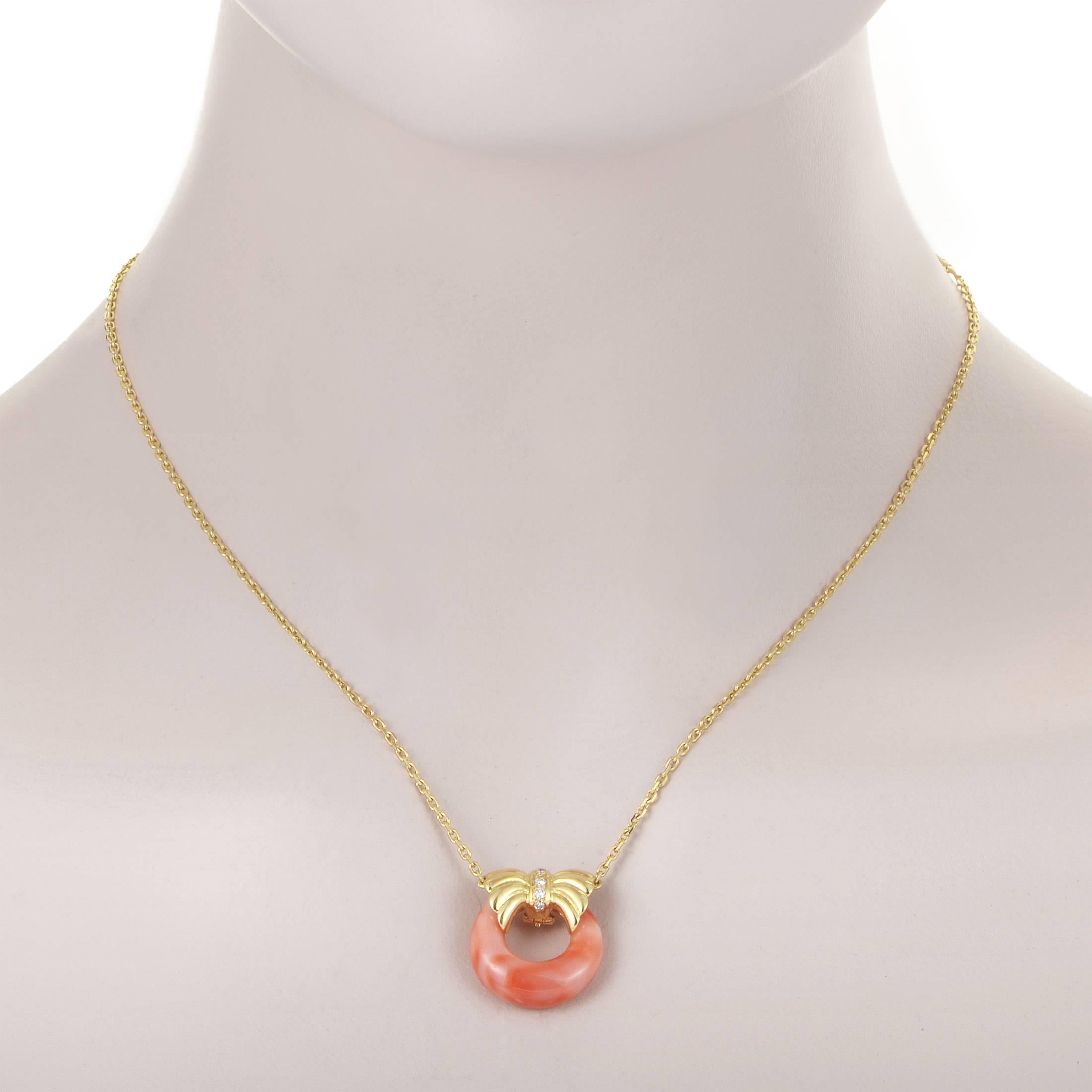 Embracing the smooth shape of the marvelous coral stone with its brilliantly designed and immaculately crafted form of a bow, the radiant 18K yellow gold in the pendant of this fabulous necklace from Van Cleef & Arpels is adorned with delicately