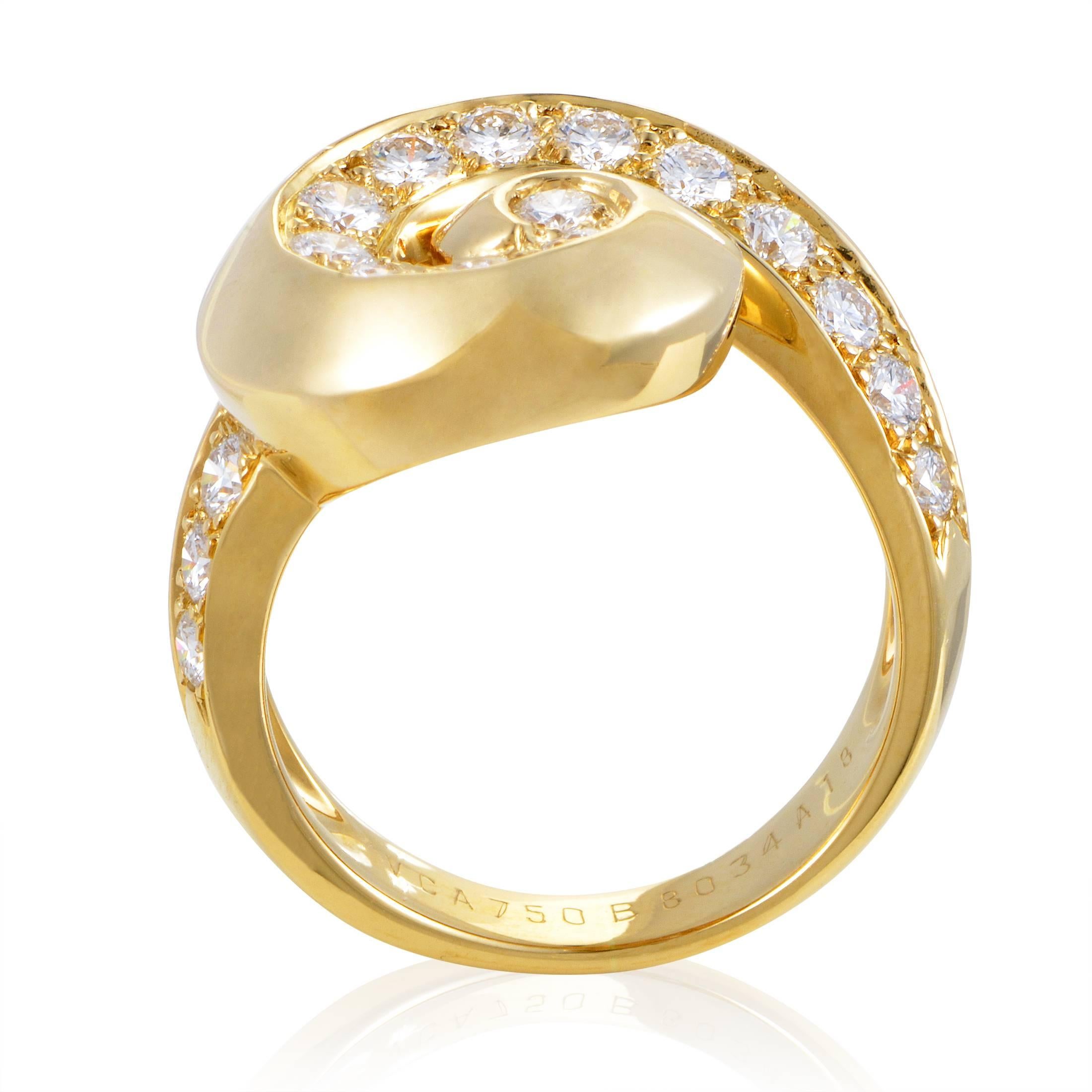 Flowing in gracefully smooth fashion and creating a wonderfully appealing shape in the process, the magnificent 18K yellow gold body of this spellbinding ring from Van Cleef & Arpels is polished to perfection and adorned with lustrous diamonds