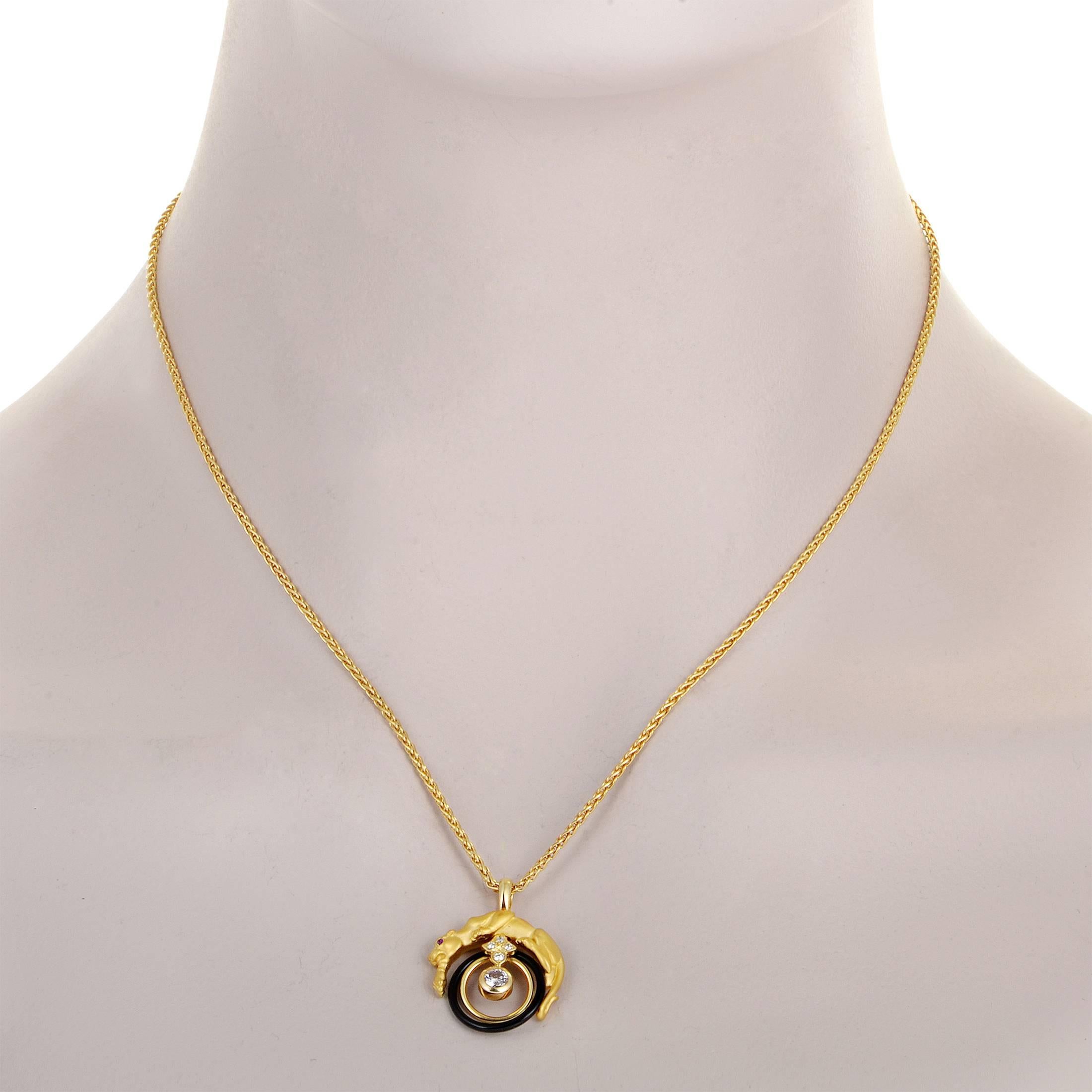 Boasting their instantly recognizable and esteemed motif of a majestic panther, Carrera y Carrera present this fabulous 18K yellow gold necklace which features a stunning ring-shaped onyx, a ruby, and sparkling diamonds totaling 0.22ct in its