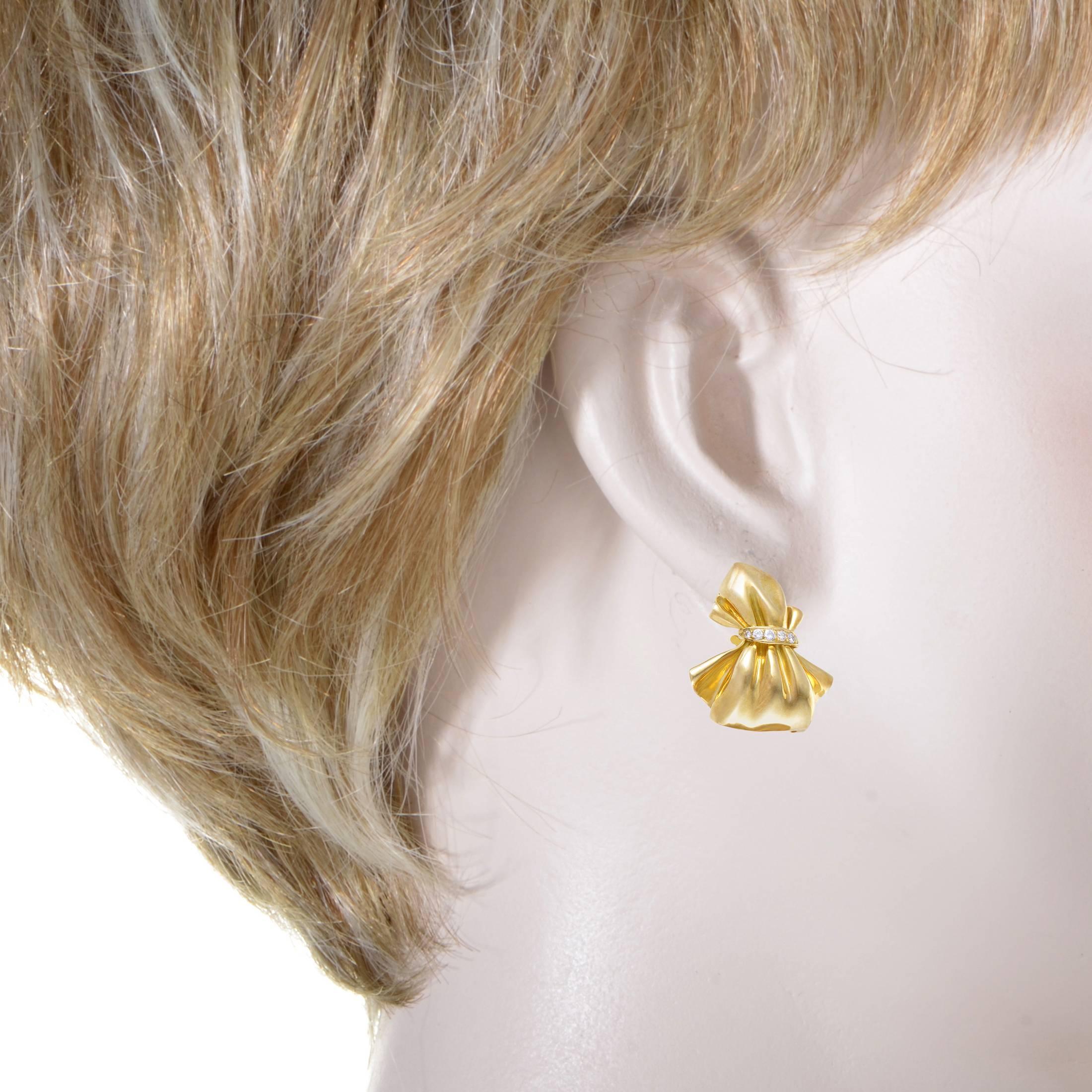 Brilliantly envisioned and crafted with extraordinary expertise to depict in astoundingly realistic fashion the adorable motif of a bow, these magnificent 18K yellow gold earrings from Van Cleef & Arpels are embellished with lustrous diamonds