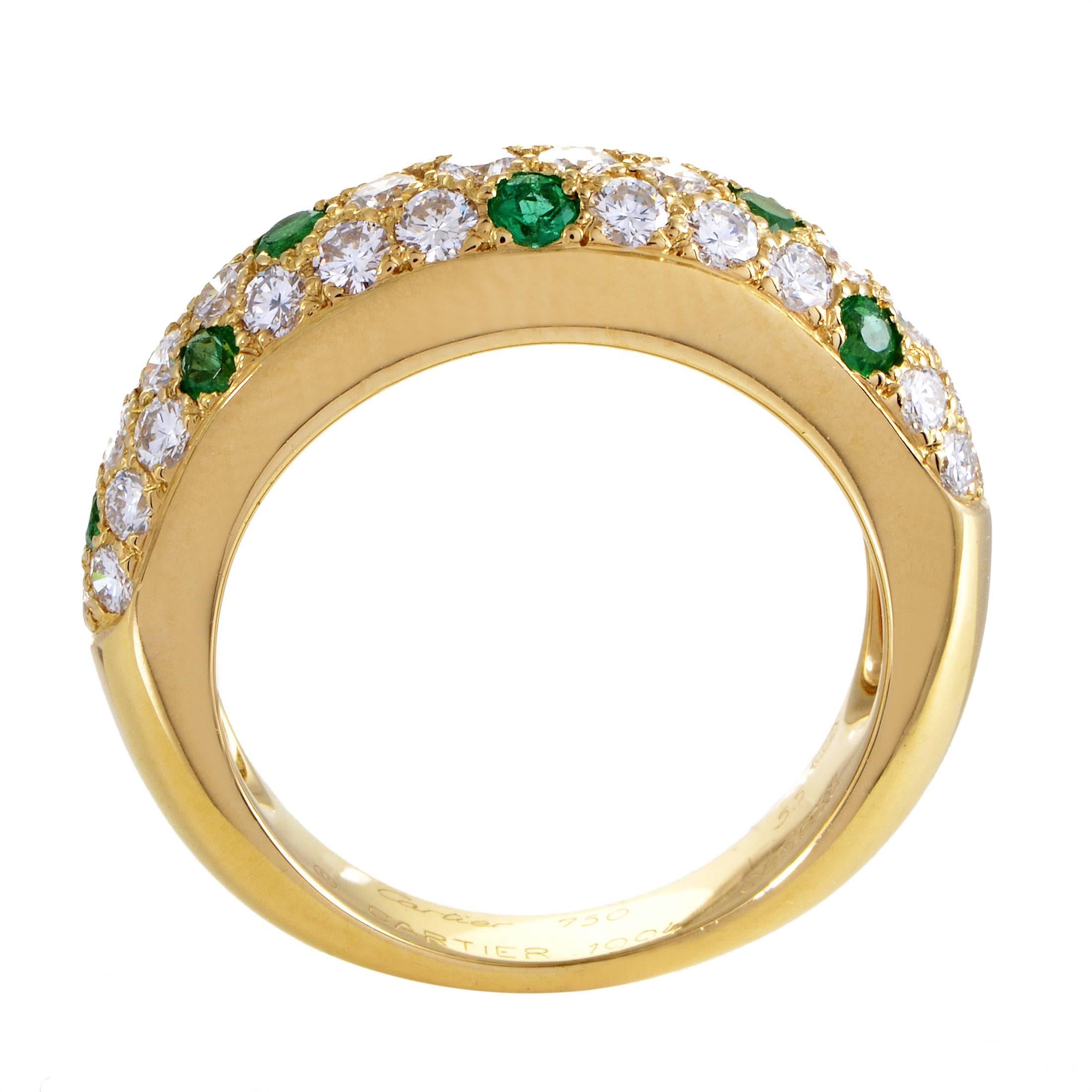 Prestigious excellence and tasteful elegance grace this magnificent ring from Cartier with immense allure, boasting a scintillating blend of sparkling diamonds totaling 1.00 carat and nifty emeralds amounting to 0.50ct set against the charming 18K