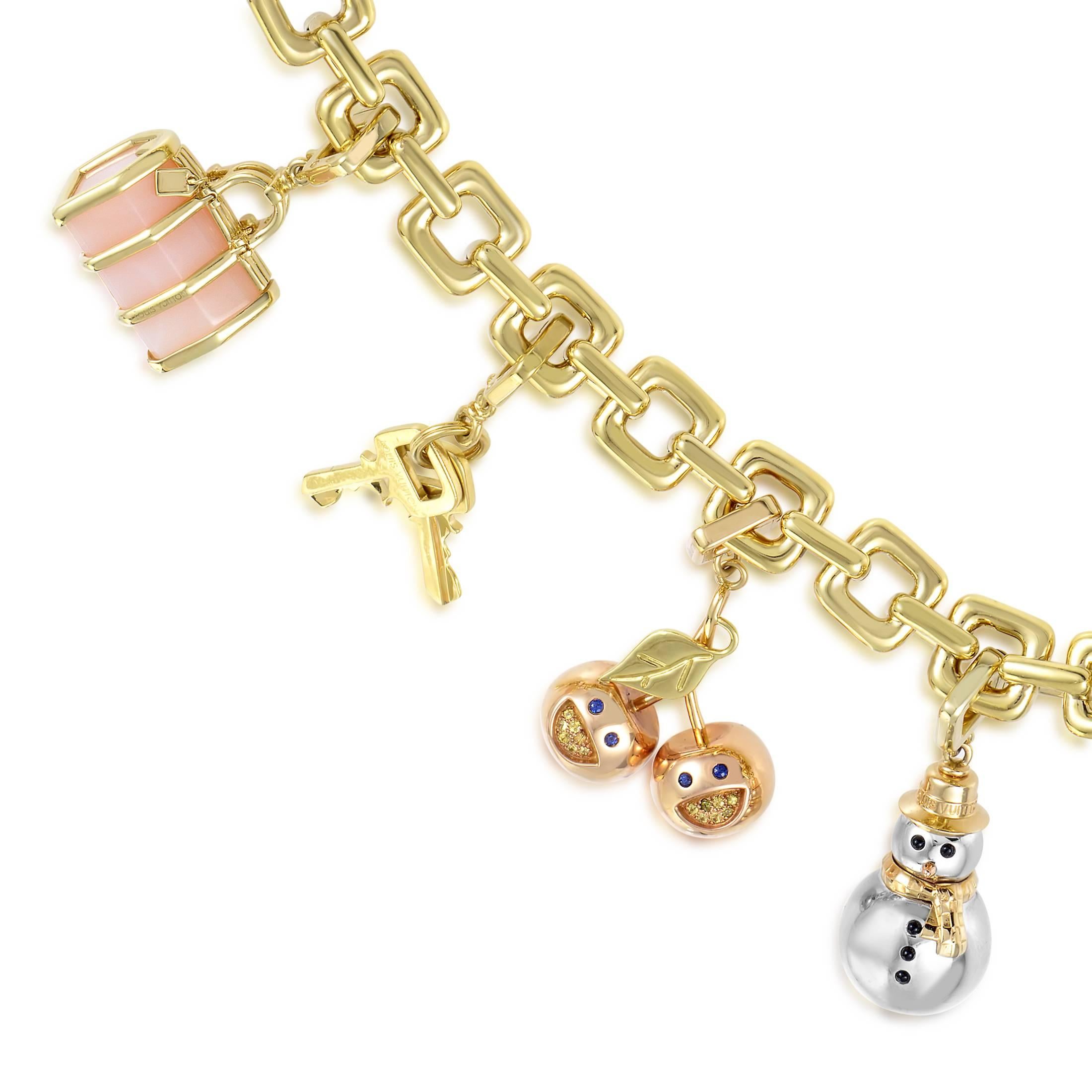 Boasting an intriguing lock as a clasp, this enchanting 18K yellow gold bracelet from Louis Vuitton is adorned with pink quartz stones as well as yellow and blue sapphires while lined with a wonderful selection of charms that includes a set of keys,