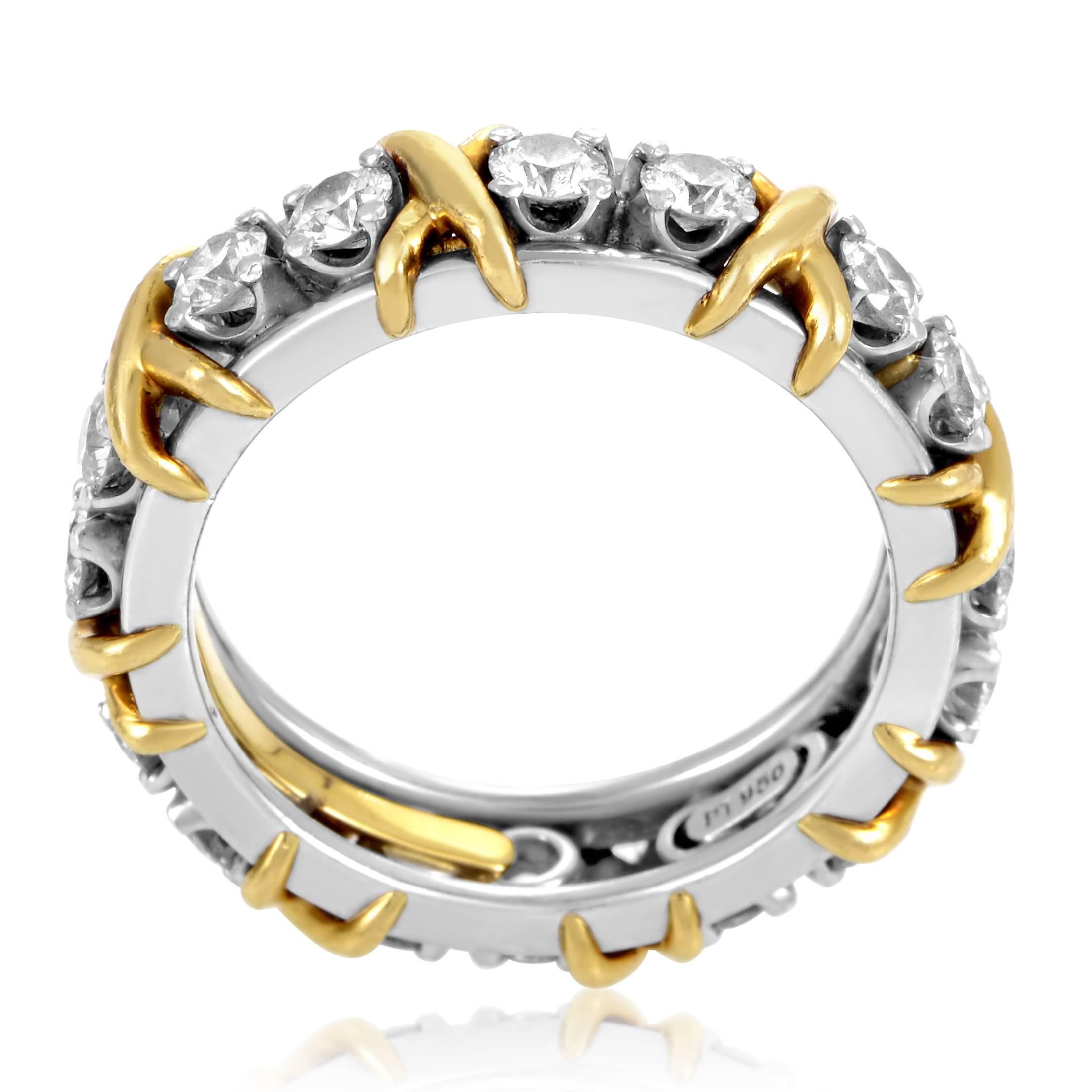 Tastefully interspersed with intriguing 18K yellow gold segments which break the harmonious bright tone, lustrous diamonds weighing in total 1.14 carats are placed upon precious platinum in this fascinating band designed by Jean Schlumberger for