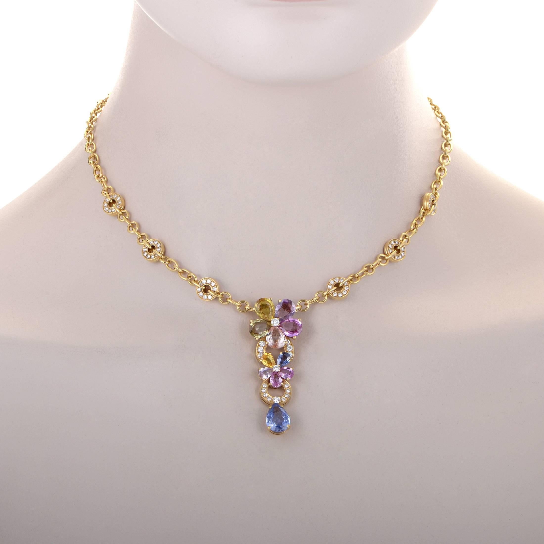 Brilliantly ornate and dazzling, this astonishing 18K yellow gold necklace from Bulgari boasts enchanting floral décor comprised of multicolored sapphires totaling approximately 11.00 carats and sparkling diamonds amounting to 2.15 carats for a