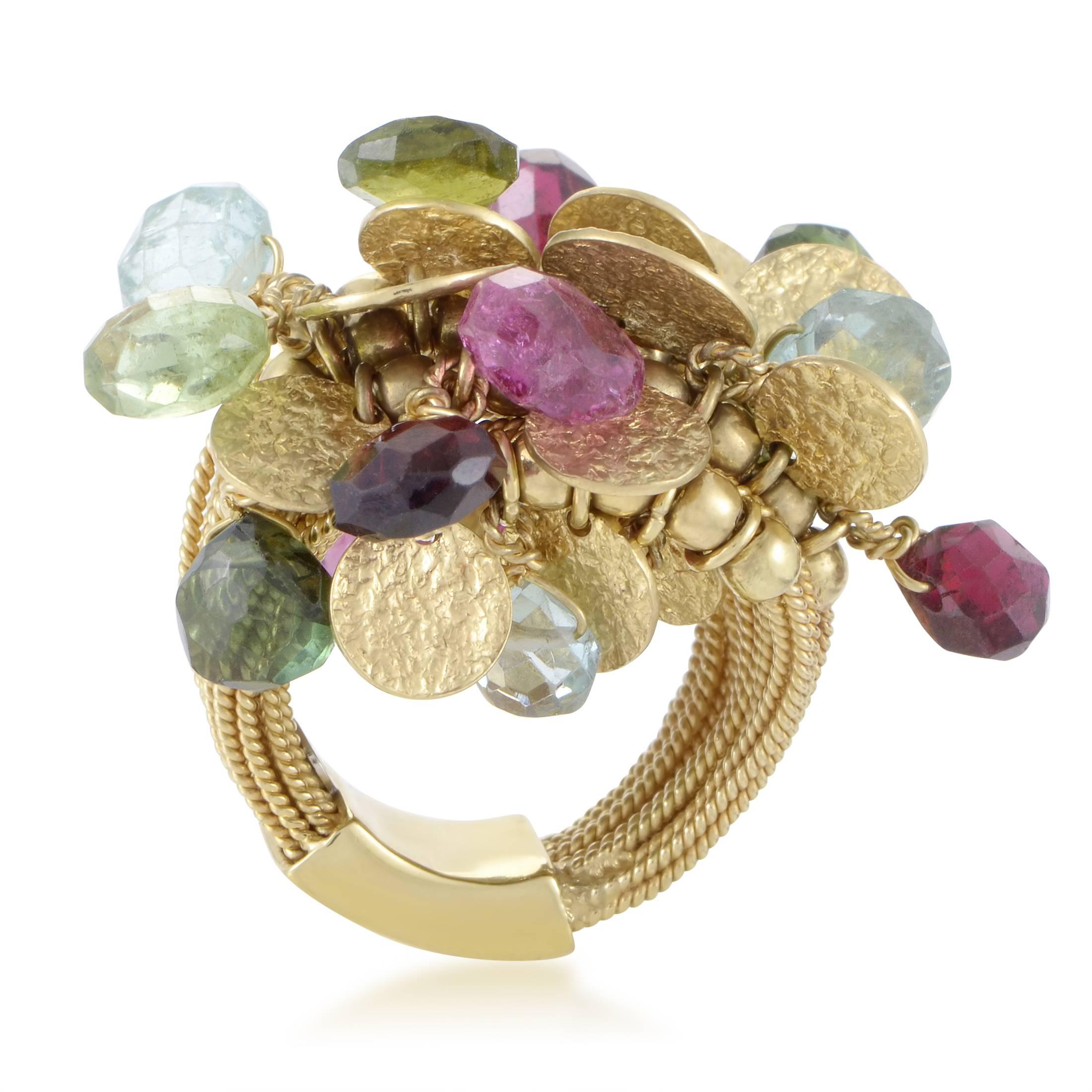 With an unconventional design of the intricately ornamented 18K yellow gold body as well as intriguingly finished coin-shaped 18K yellow gold charms, this extraordinary ring from Catherine Prevost also boasts a fascinating arrangement of