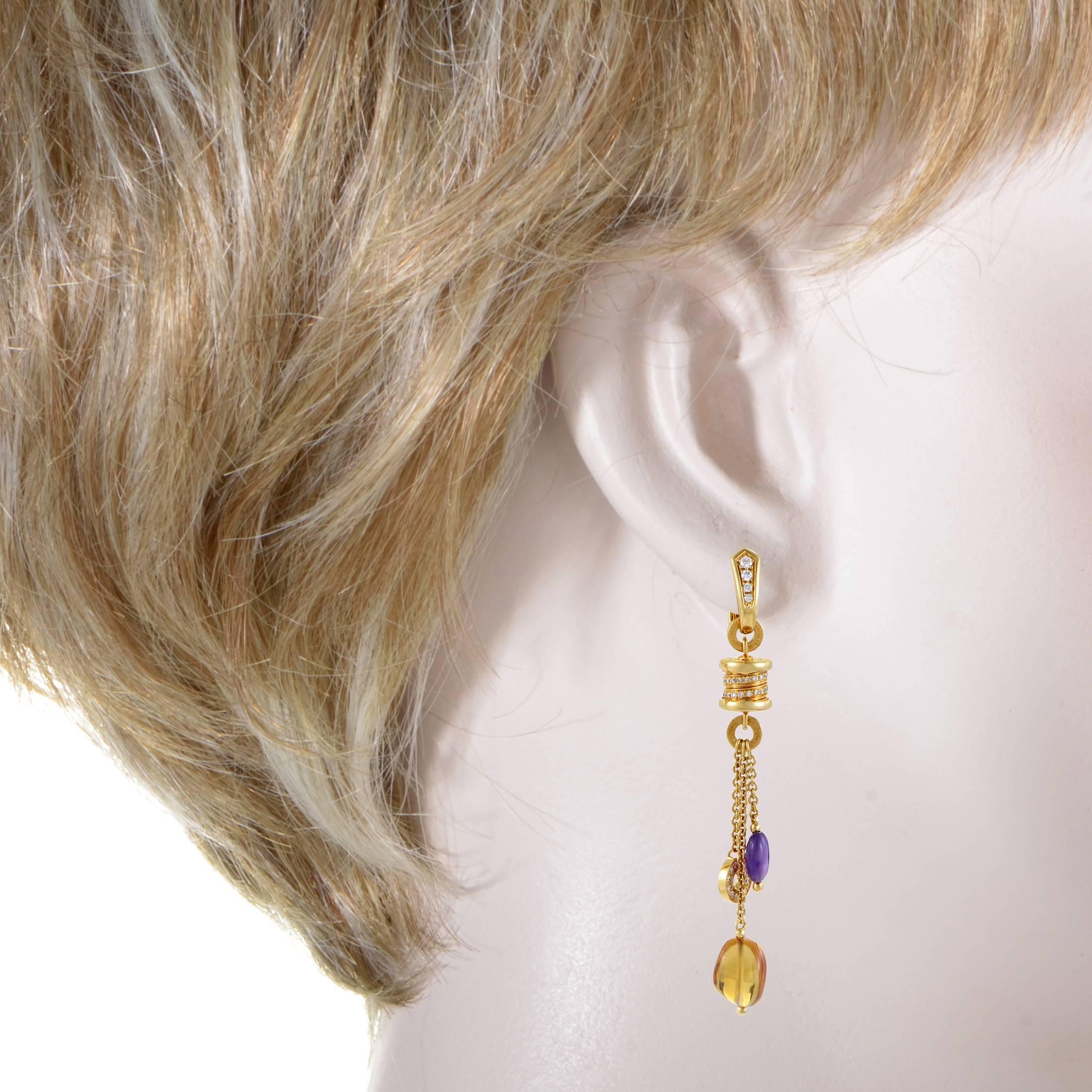 The Bulgari B.Zero1 collection features festive designs that will take your style to the next level. This genuine pair of earrings from the collection are made of 18K yellow gold and are set with diamonds. Lastly, multi-colored gemstones dangle from