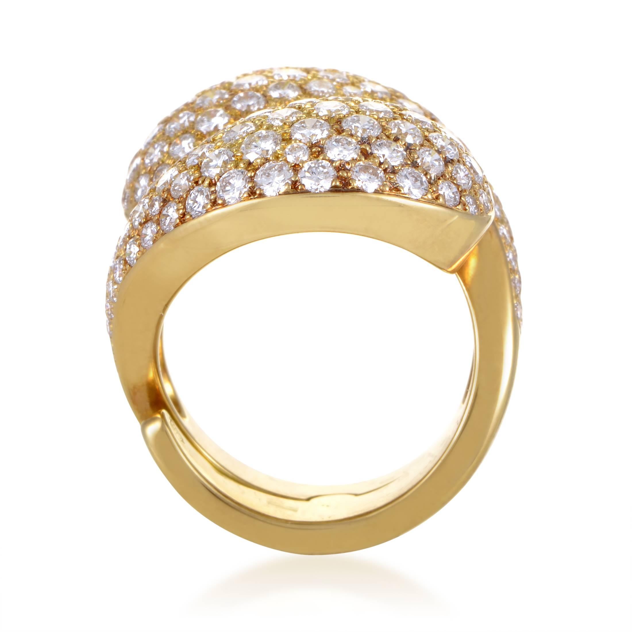 A bounty of gold and diamonds cinches into a spectacular ring design from Cartier. Two twining branches of 18K yellow gold rise in their embrace, then burst into a canopy of pave diamonds. The multitude of diamonds settings weigh in at 5.25ct, and