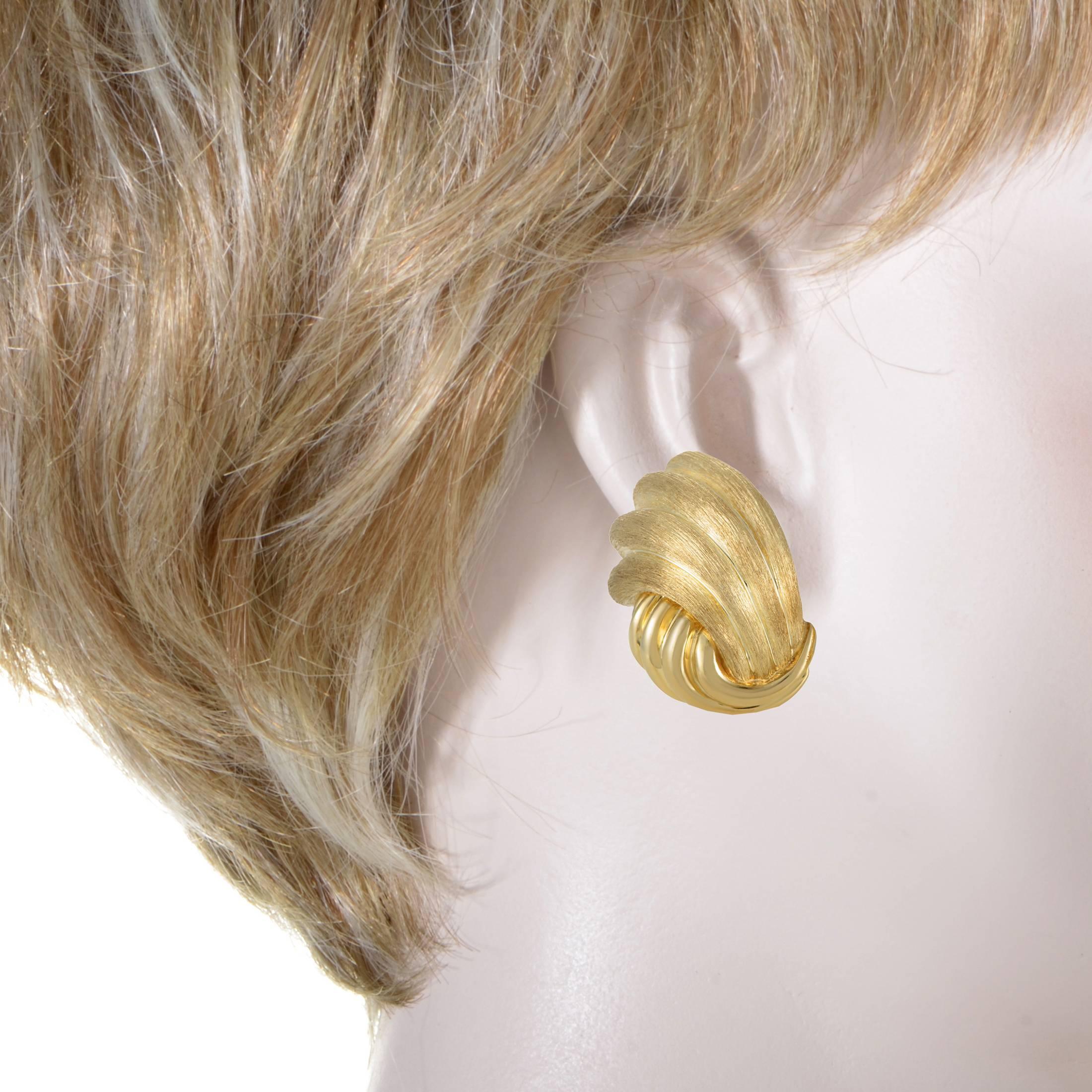 Employing two diverse and exquisite finishes to grace a wonderful shape with fascinating allure, Henry Dunay created these exceptional earrings made of immaculately polished and fine brushed 18K yellow gold for captivating play of light.