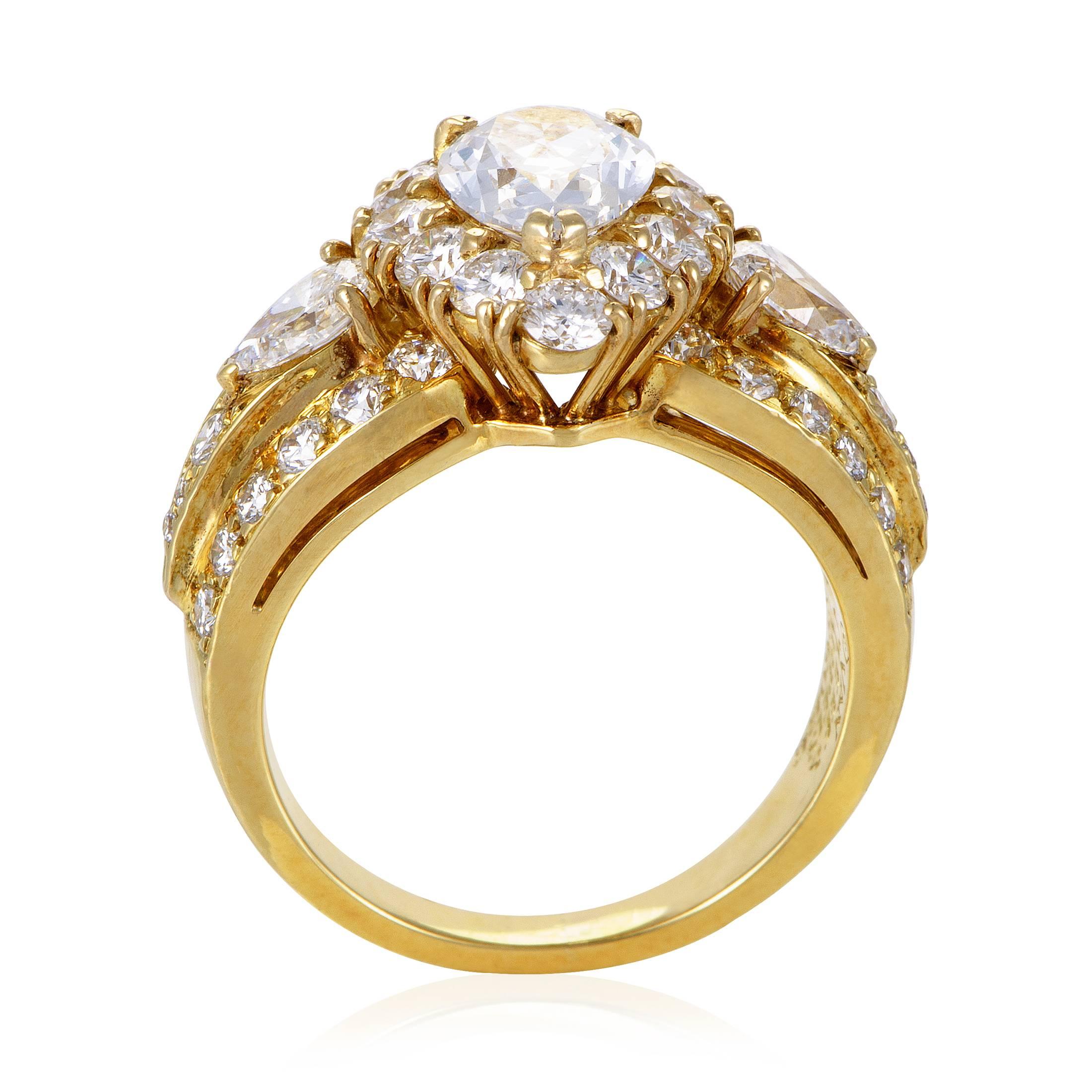 Rich with diamond resplendence and gold radiance, this majestic engagement ring from Van Cleef & Arpels is made of 18K yellow gold and embellished with dazzling EF-colored diamonds of VVS clarity totaling 1.75 carats with a stunning central