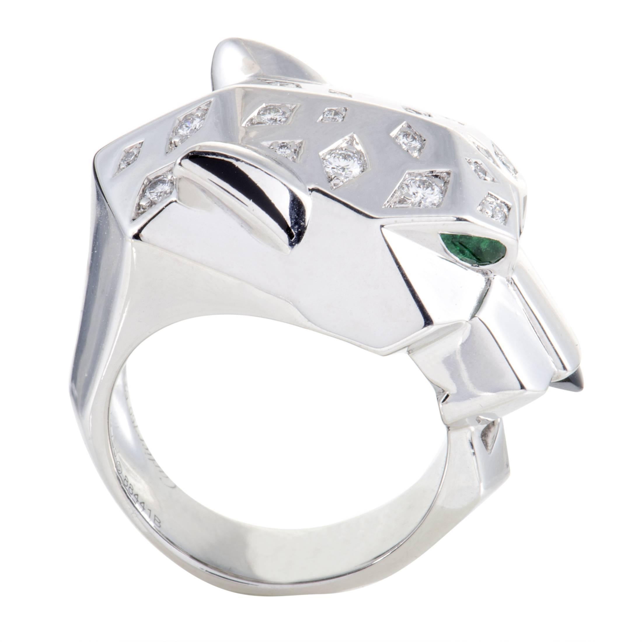 Bold style and remarkable quality produce a compelling allure in this fantastic 18K white gold ring from Cartier which is crafted in their emblematic form of a panther while set with glistening diamonds, nifty emeralds and a stunning onyx