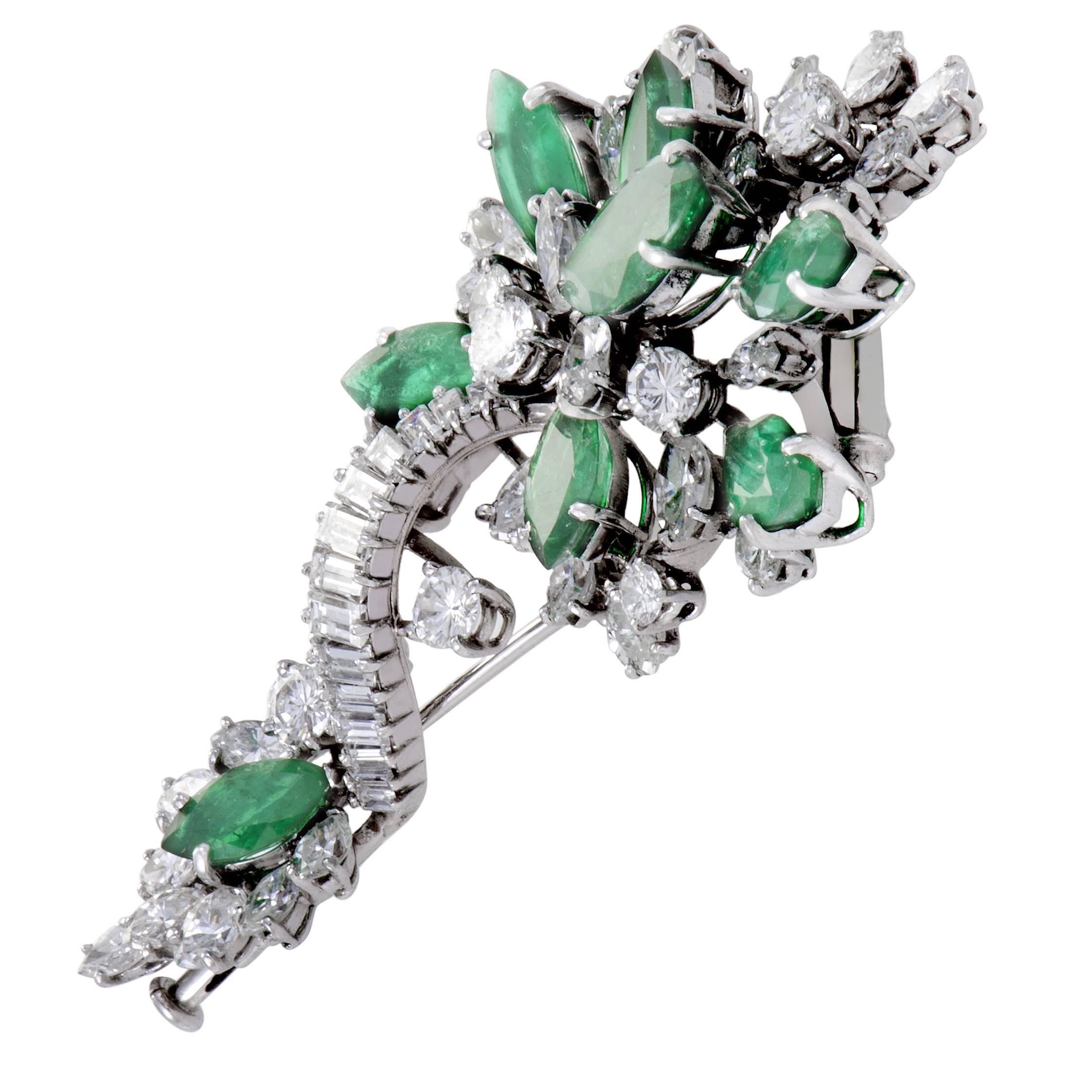 Lending their appealing and eye-catching color to a harmoniously bright design, stunning emeralds totaling 8.00 carats are scattered among sparkling diamonds amounting approximately to 7.00 carats in this stylish brooch made of 18K white gold.