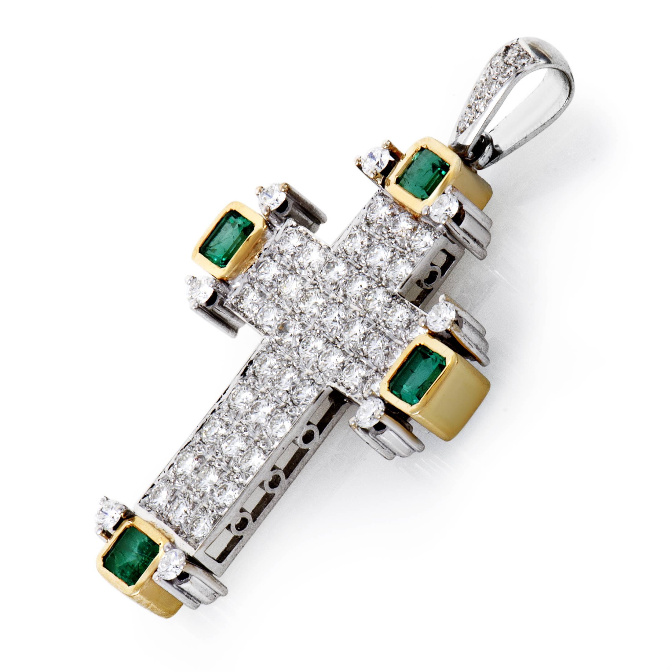 Symbolically powerful and aesthetically appealing, this fantastic cross-shaped pendant is made of 18K white and yellow gold while adorned with scintillating H-color diamonds of VS clarity totaling approximately 2.30 carats as well as nifty emeralds