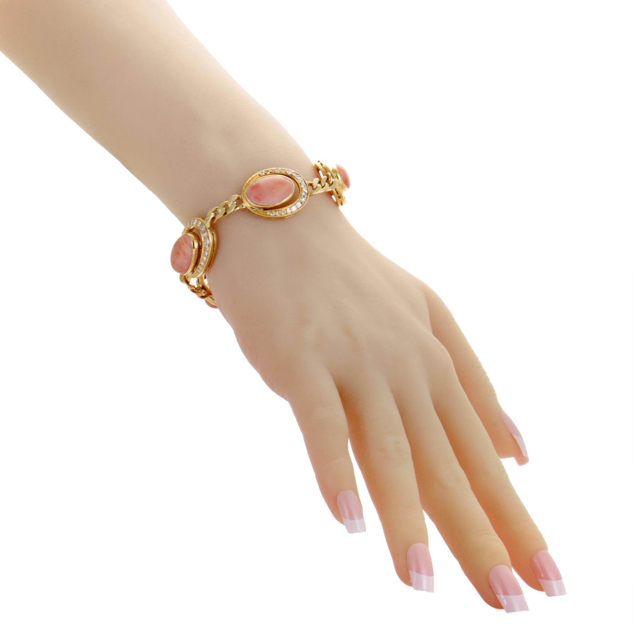 Encircled with approximately 2.00 carats of lustrous diamonds, the marvelous coral stones stand out in brilliant fashion to produce an enchanting vintage allure in this gorgeous 18K yellow gold bracelet which offers a stylish and resolutely feminine