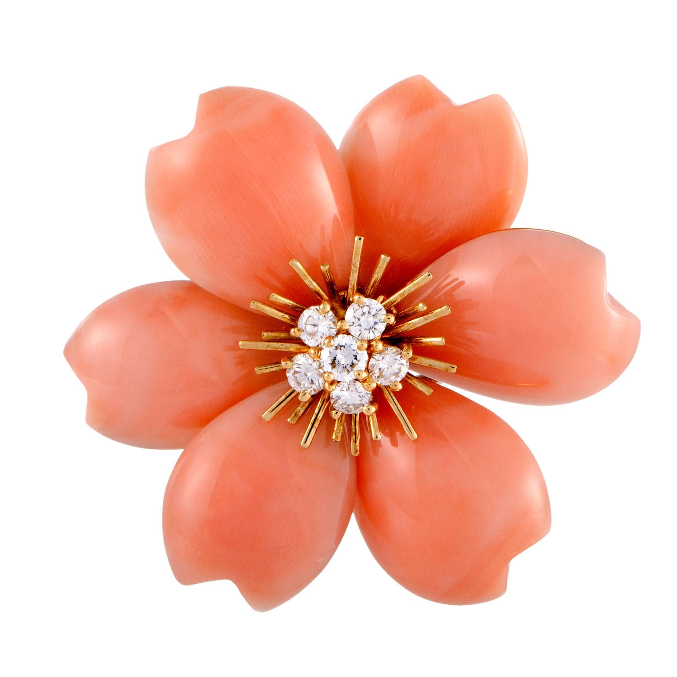 Presenting the adorable motif of a flower in a fabulously feminine blend of radiant 18K yellow gold and marvelous coral stones, Van Cleef  Arpels created these enchanting earrings which also boast sparkling diamonds amounting to 1.50 carats for an
