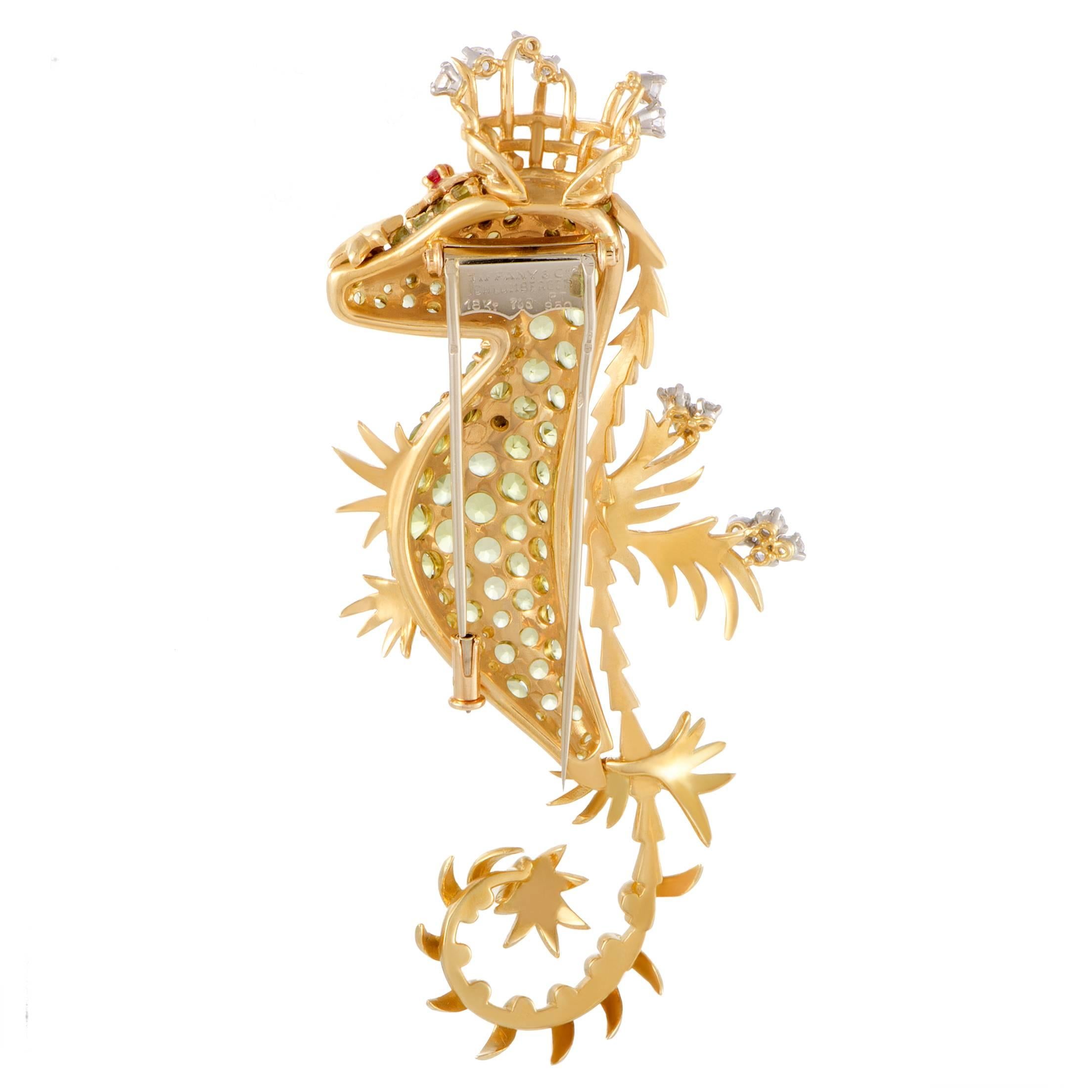 Designed by Jean Schlumberger for the world-renowned brand, this stunning Tiffany & Co. brooch is made of elegant 18K yellow gold in the form of a seahorse. It is lavishly set with spectacular diamonds and rubies and resplendent