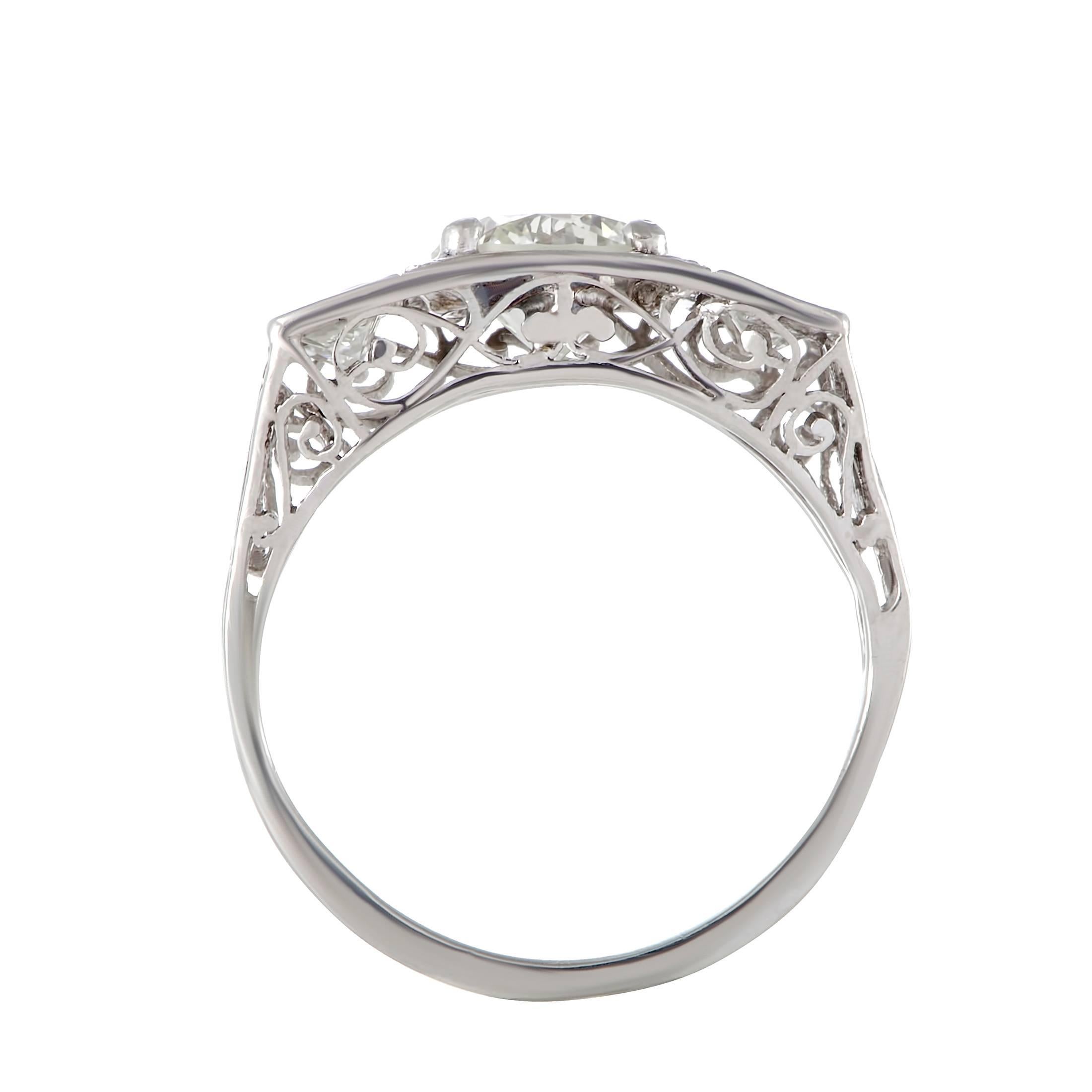 Alluringly intricate design and spectacular décor create a spellbinding effect in this stunning ring made of prestigious platinum that offers sublime elegant look. The ring is set with a gorgeous center diamond of K-color and VS1 clarity weighing