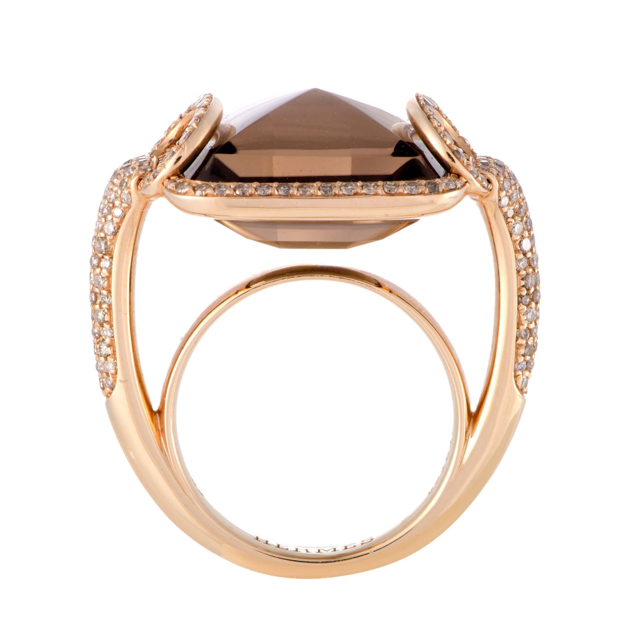 Bring a substantial dose of bling to your ensembles with this Hermes ring that's poised to garner attention at a cocktail party. Fashioned from 18K rose gold, this ring features a pyramid-shaped smoky quartz stone, surrounded by brilliant cut