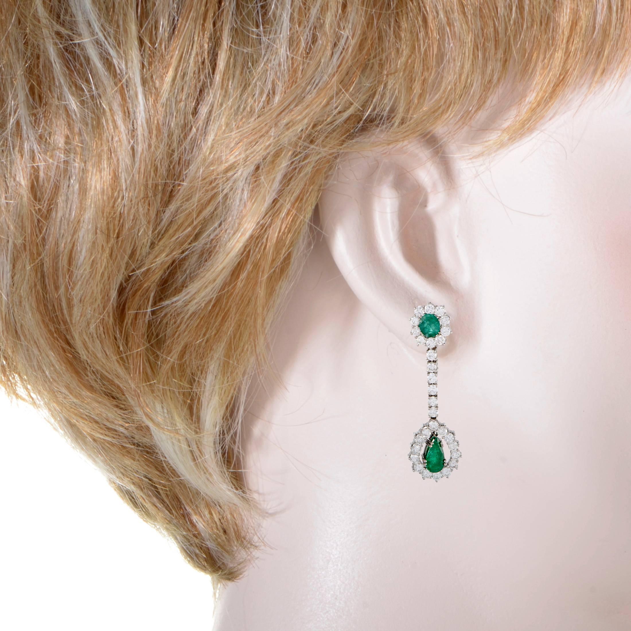 Wonderfully designed and luxuriously embellished, these gorgeous earrings feature an incredibly stylish appeal. The pair is made of elegant 18K white gold and set with resplendent diamonds and emeralds that weigh in total approximately 4.50 carats