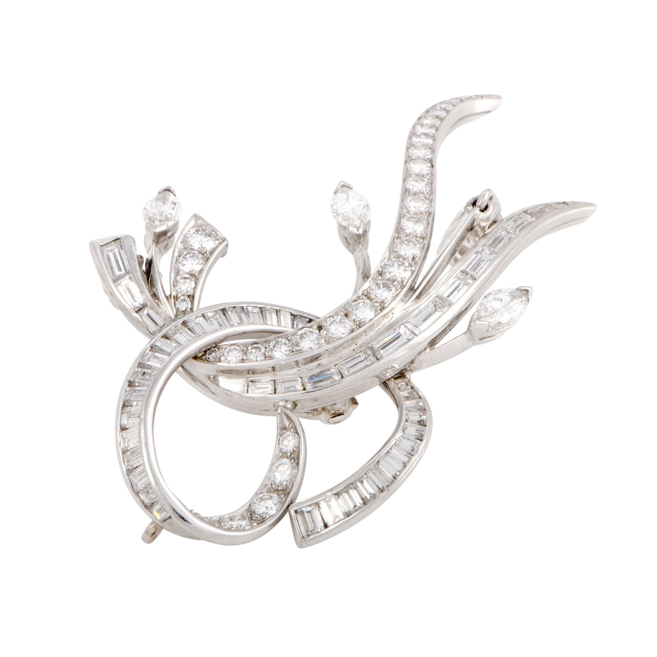 A jewelry piece that can be worn both as a brooch and as a pendant, this marvelously designed item offers an exceptionally graceful, classy look to go with its versatility. The brooch is made of prestigious platinum and set with glistening diamonds