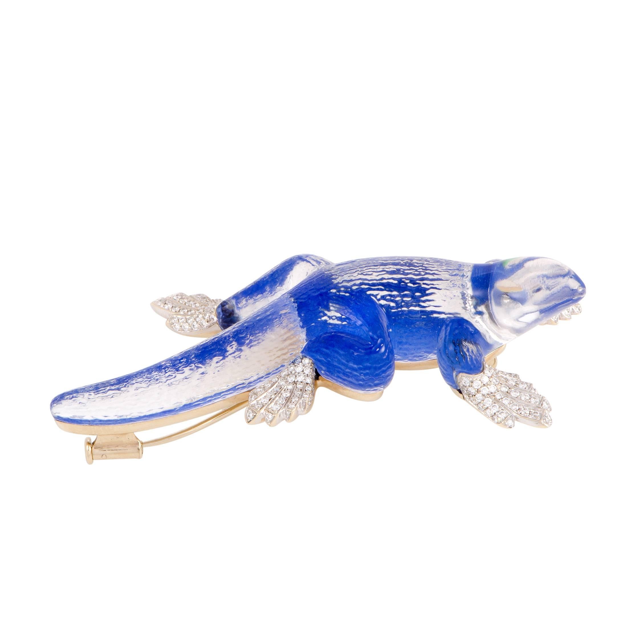 This unique pin by Vhernier is made exquisitely in rock crystal in the shape of a lizard accented with lapis lazuli. Extraordinarily designed in 18K white gold, the incredible pin has beautiful diamonds on the feet of the reptile that add a