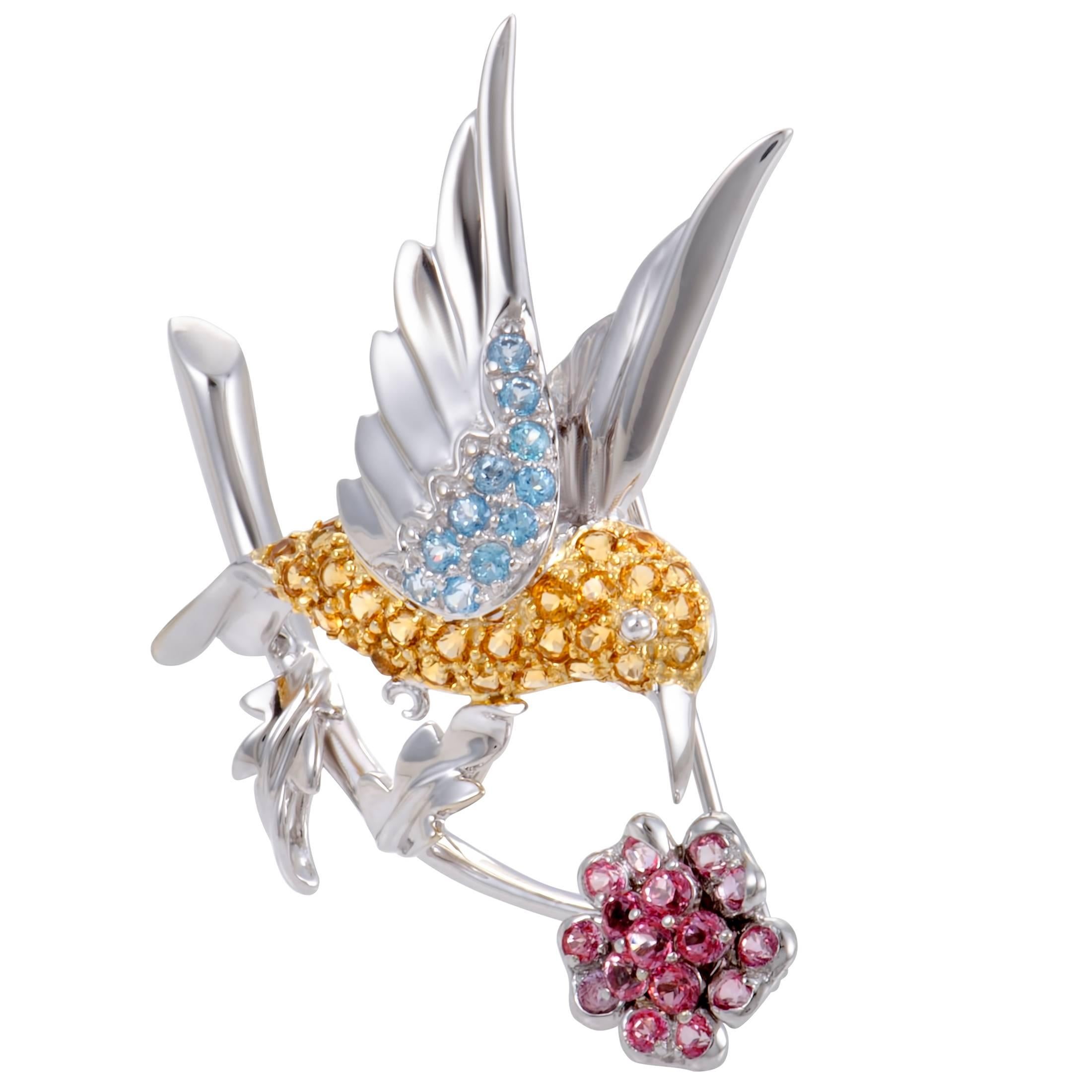 Depicting a graceful bird in a delightfully imaginative fashion, this gorgeous pin is made of 18K white gold and boasts an exceptionally attractive appeal. It is decorated with a plethora of citrines, topazes and pink tourmalines.

